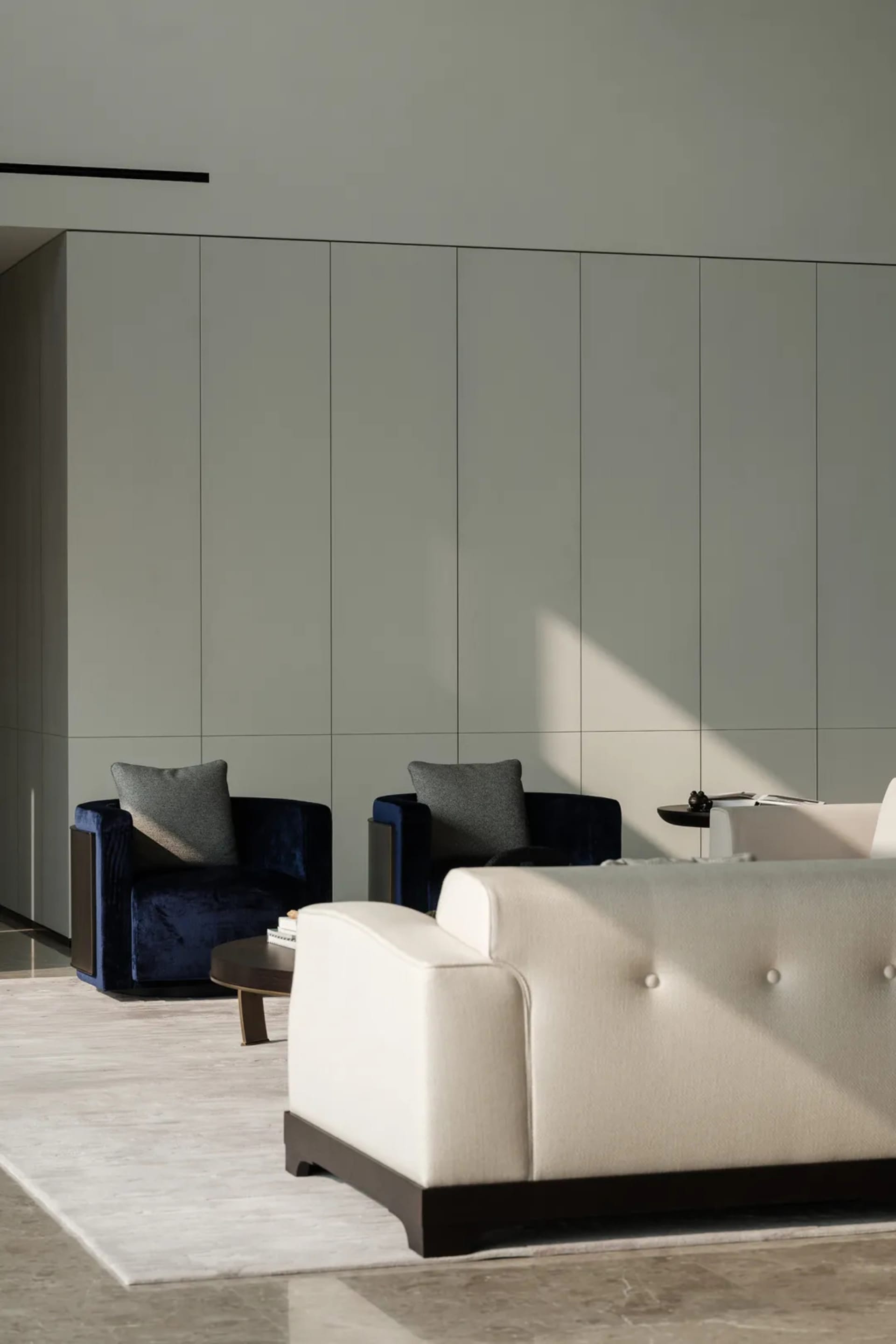Interior design featuring a modern minimalist living room with fabric furniture and a white sofa.