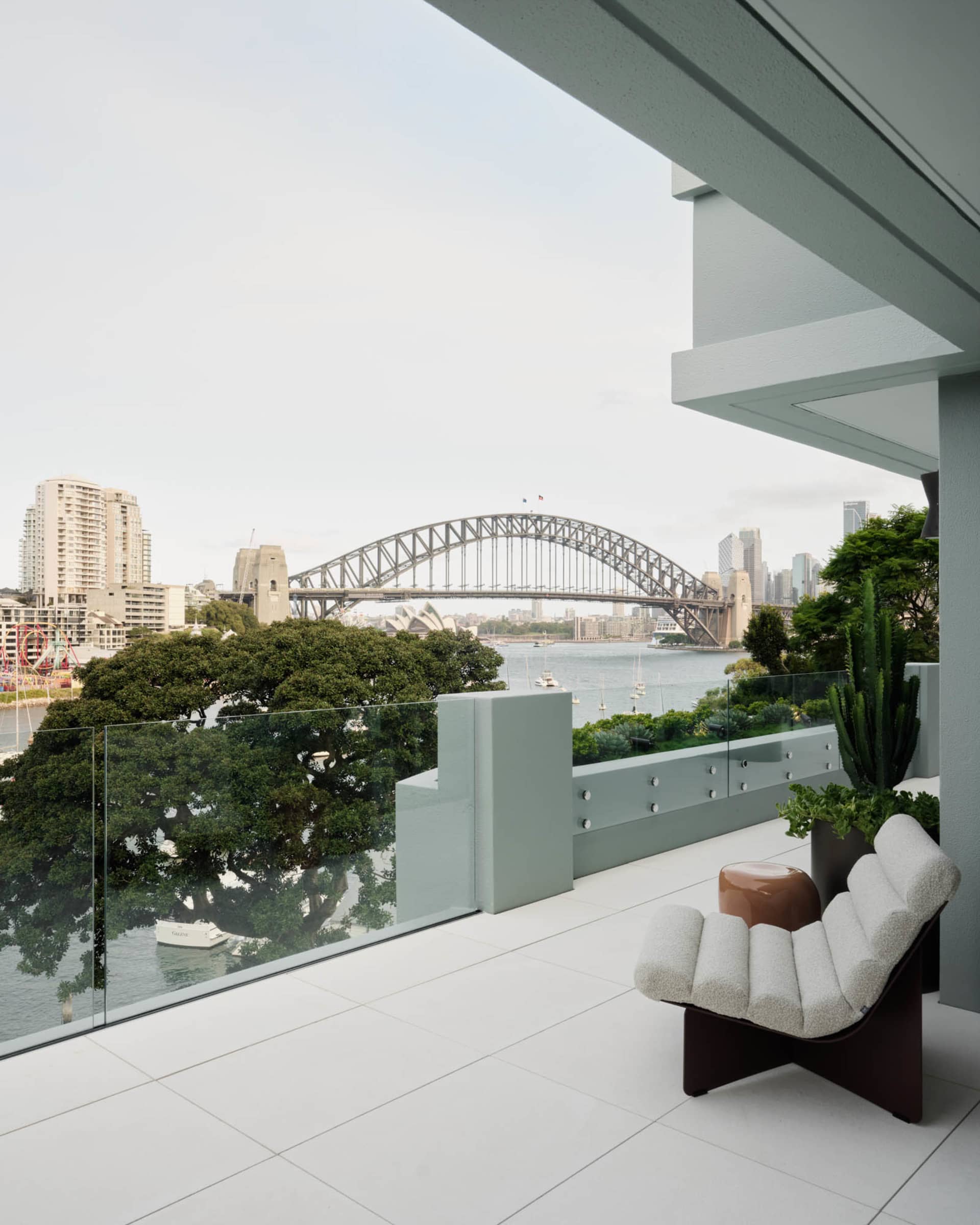 A modern balcony overlooking the city with glass railings.