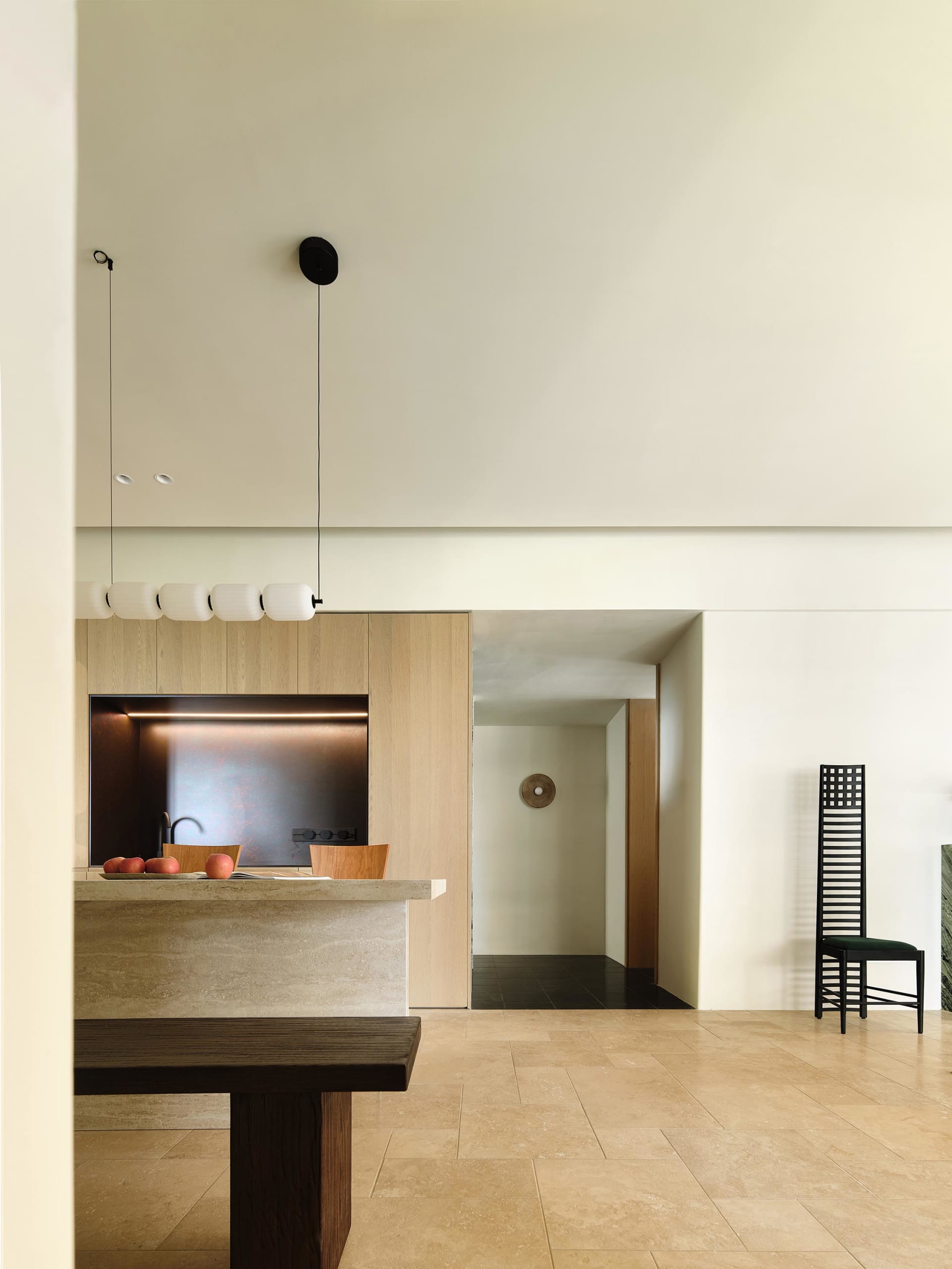 Modern kitchen featuring dark and light natural stone countertops and backsplash, with a minimalist design and sleek lines.