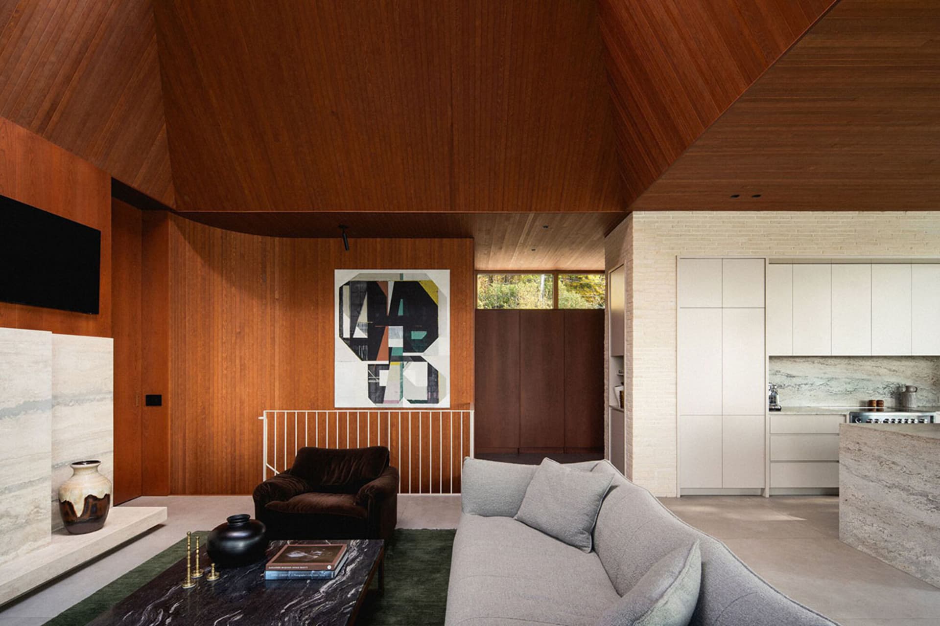 A minimalist living room featuring wooden walls, marble coffee table, and metal accents.