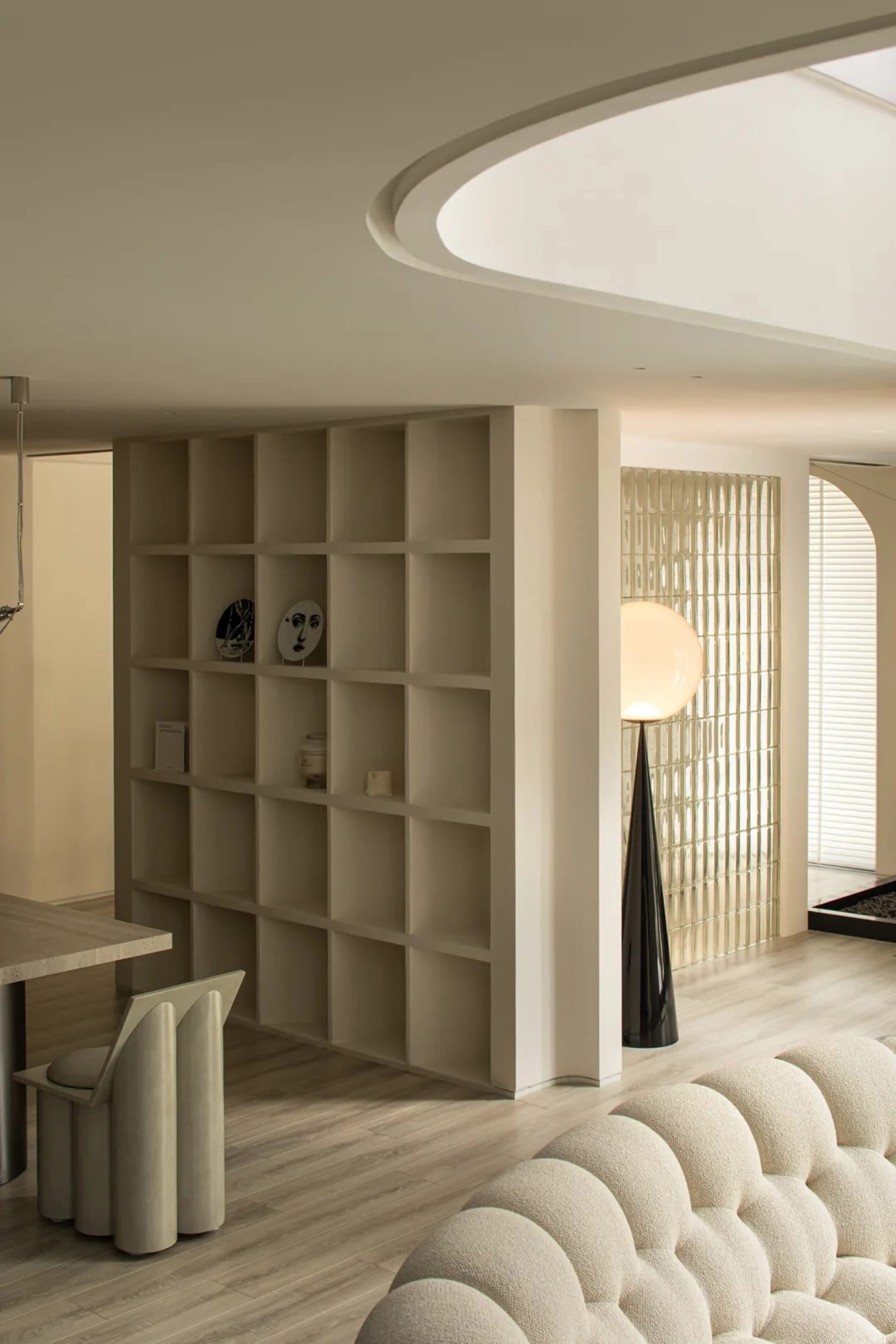 Modern living room with neutral-toned furniture and wooden flooring.