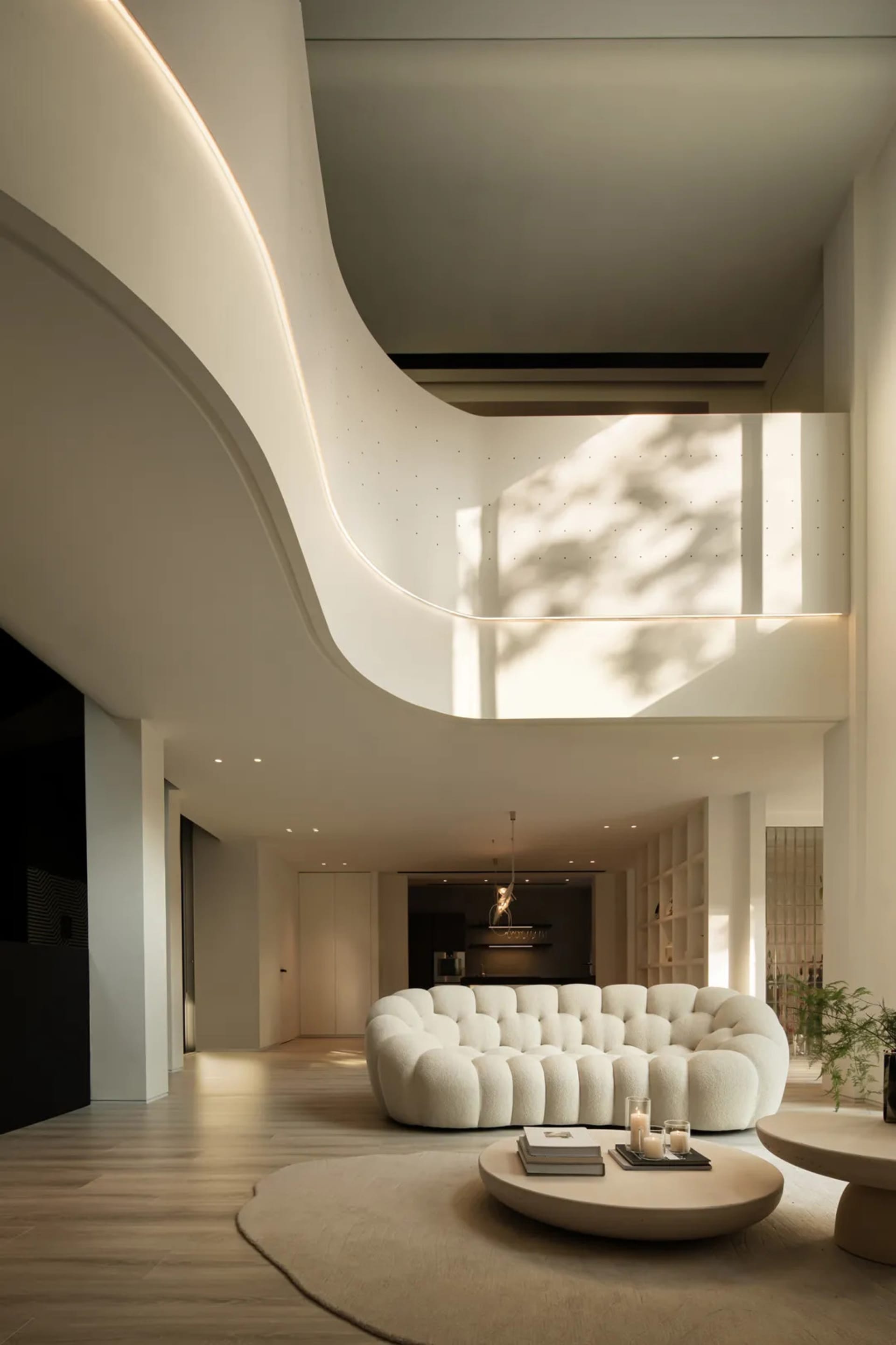 Modern living room featuring a plush sofa with soft, light-fabric upholstery, complemented by warm, ambient lighting and mini
