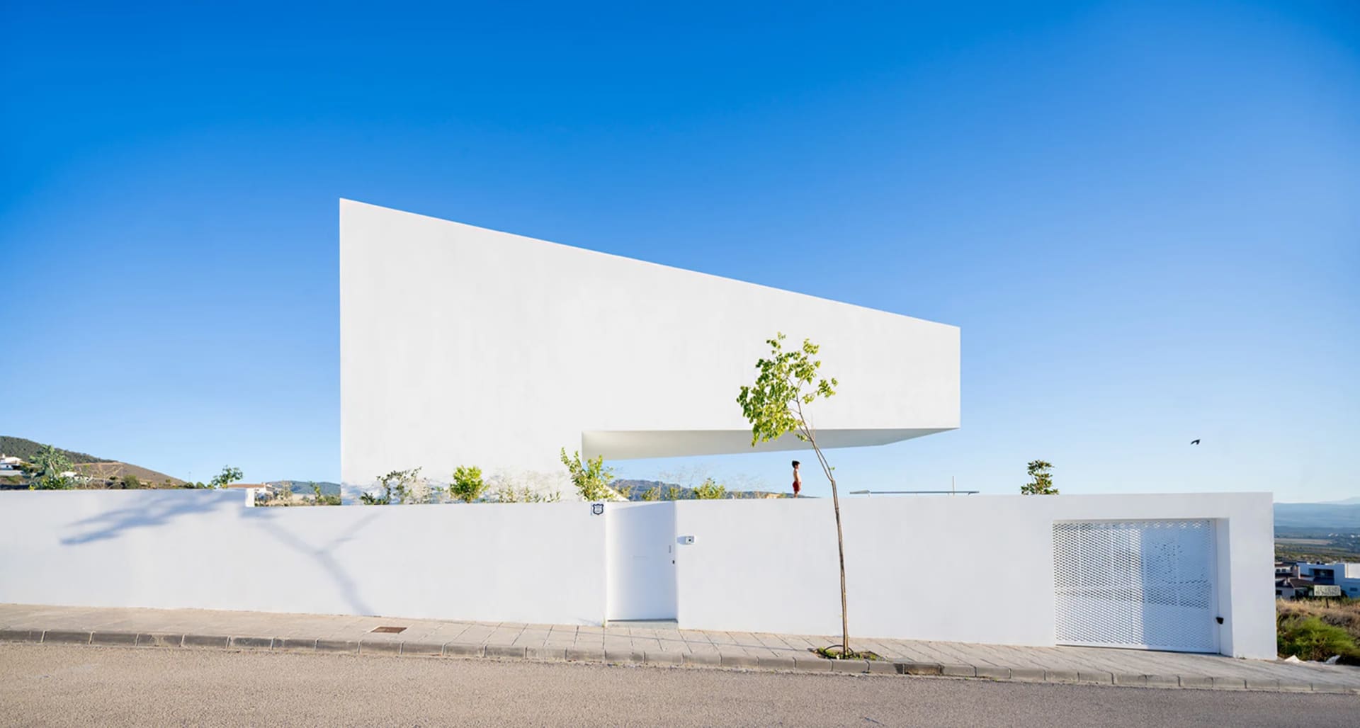 Modern white concrete house with minimalist design and open floor plan