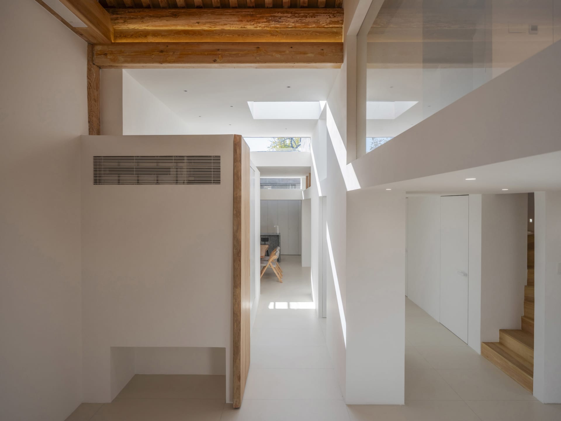 Modern interior space with white walls and flooring.