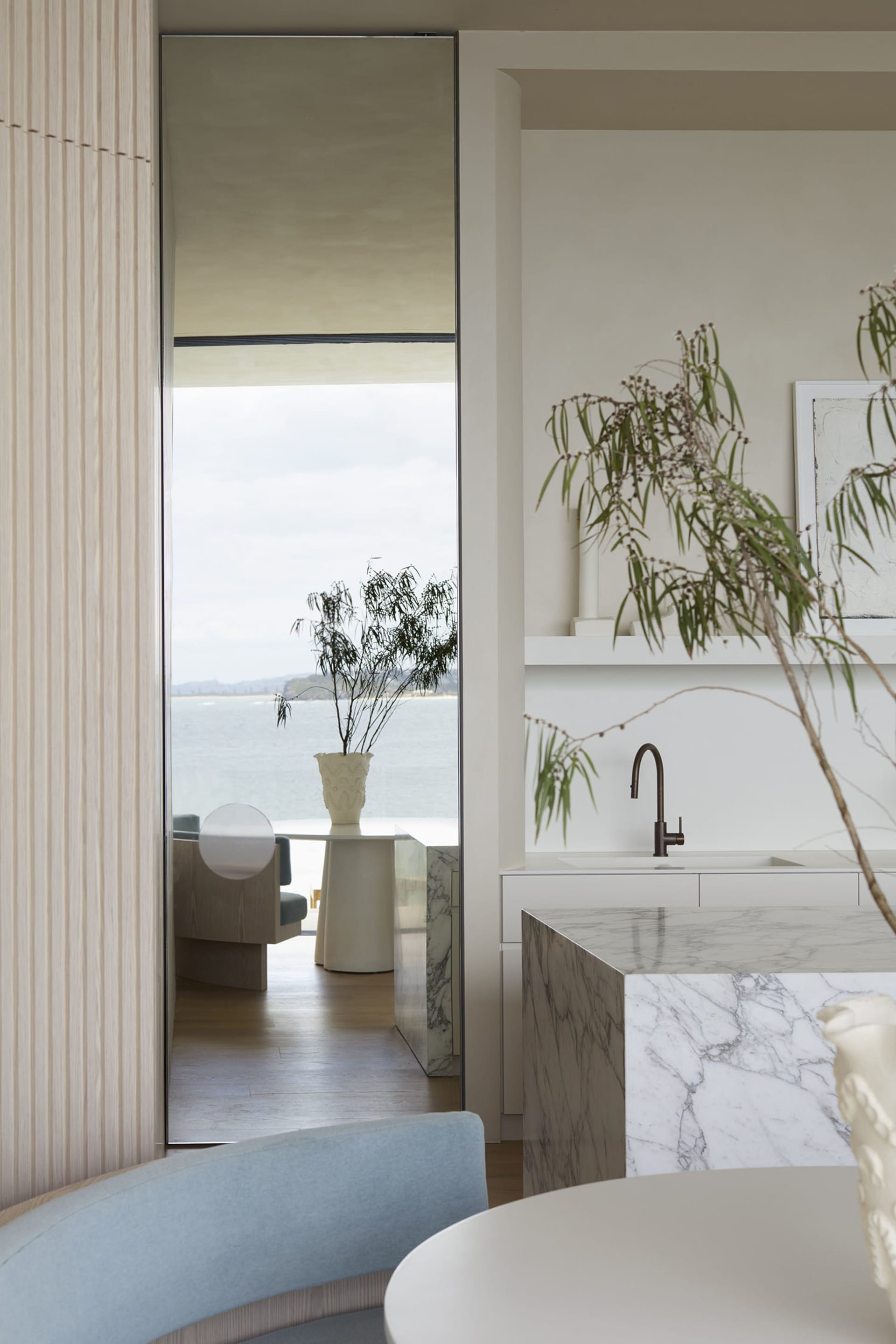 A minimalist residential kitchen featuring marble countertops and a modern, sleek design.