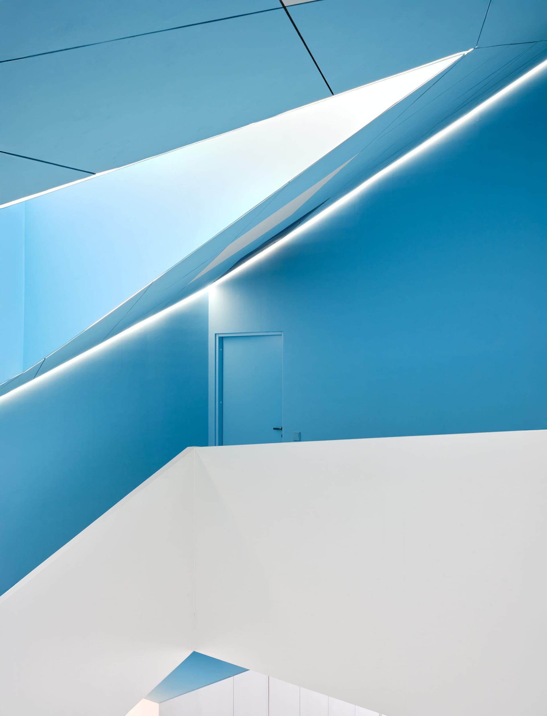 Blue and white geometric interior with concrete walls and minimalist design
