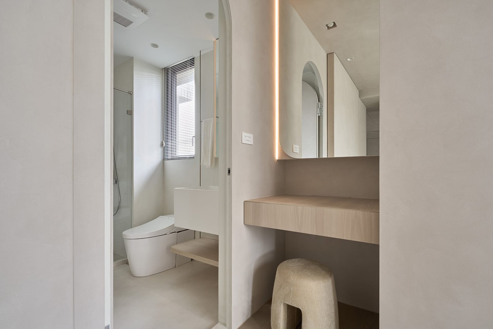 Minimalist bathroom featuring concrete materials, focused lighting, and modern design elements.