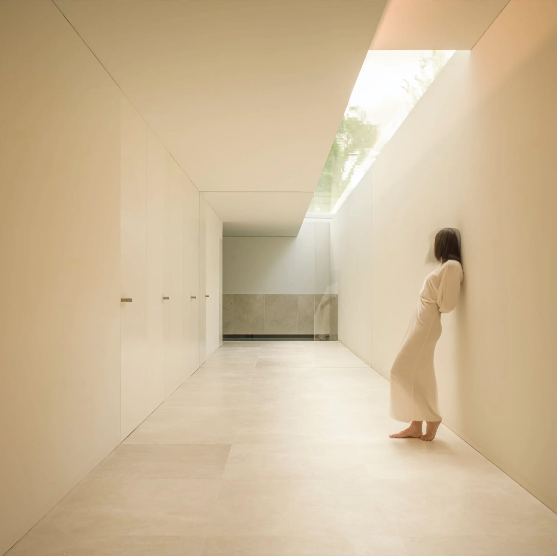 A minimalist interior space with a concrete floor and walls.