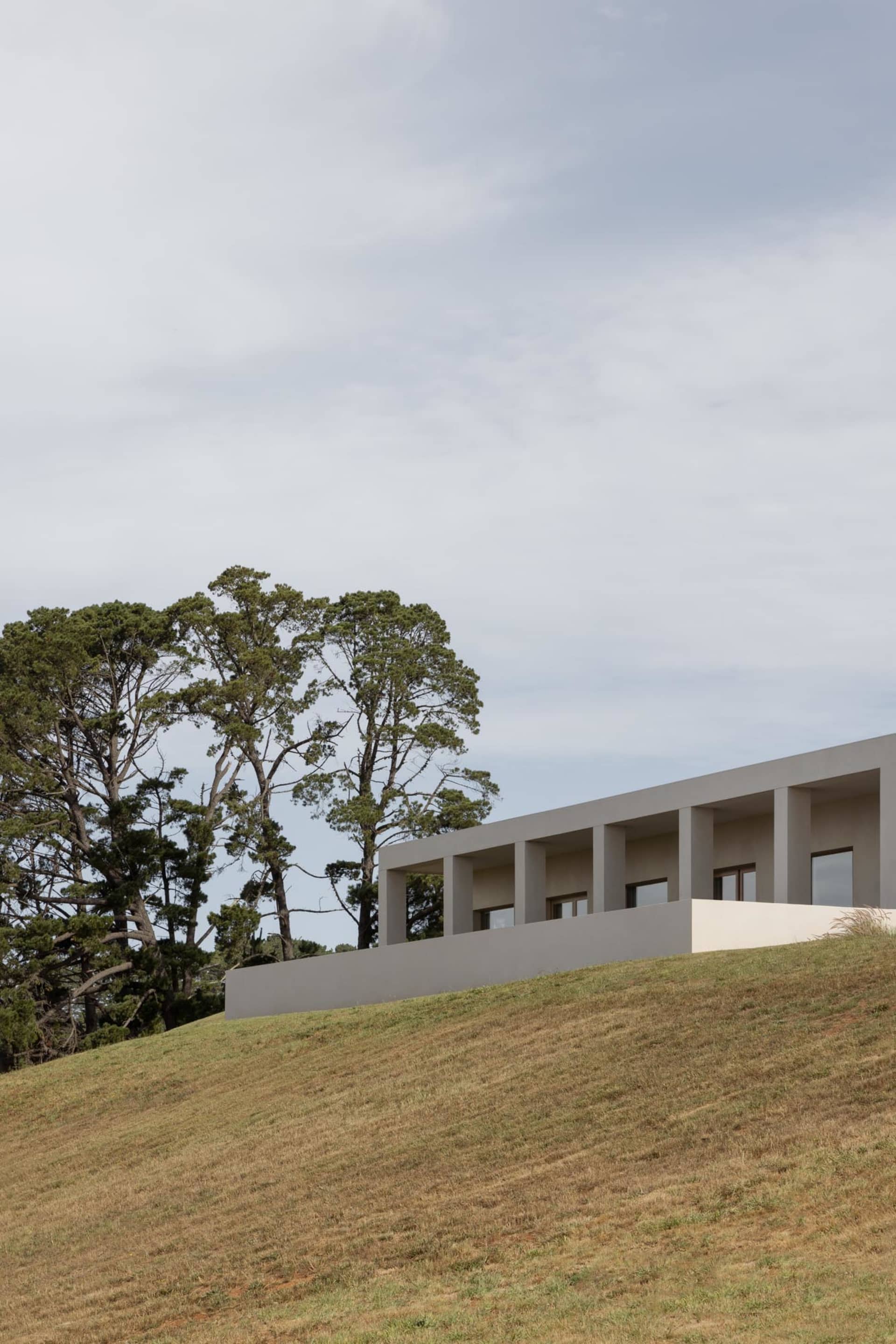 Modern residential house with concrete walls and a flat roof.