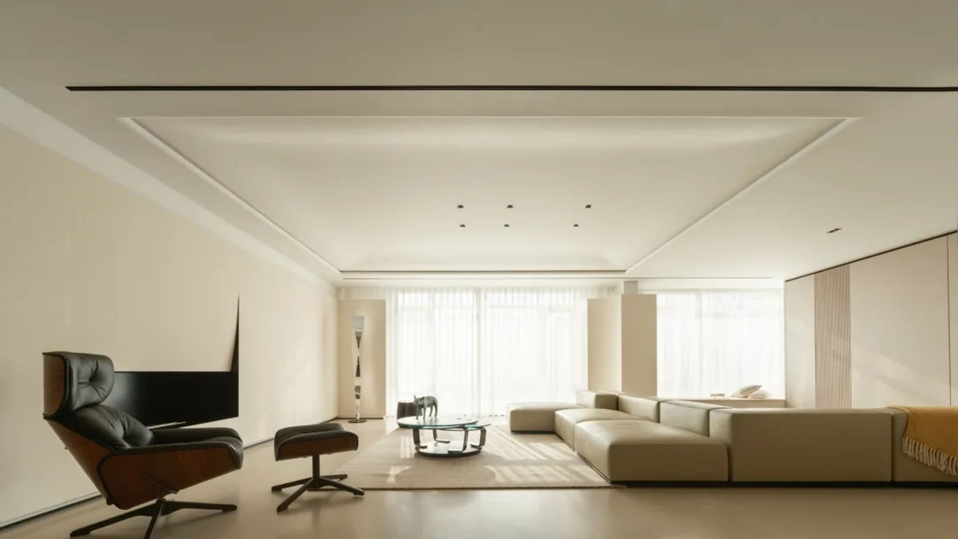 Minimalist living room with modern furniture and neutral tones.