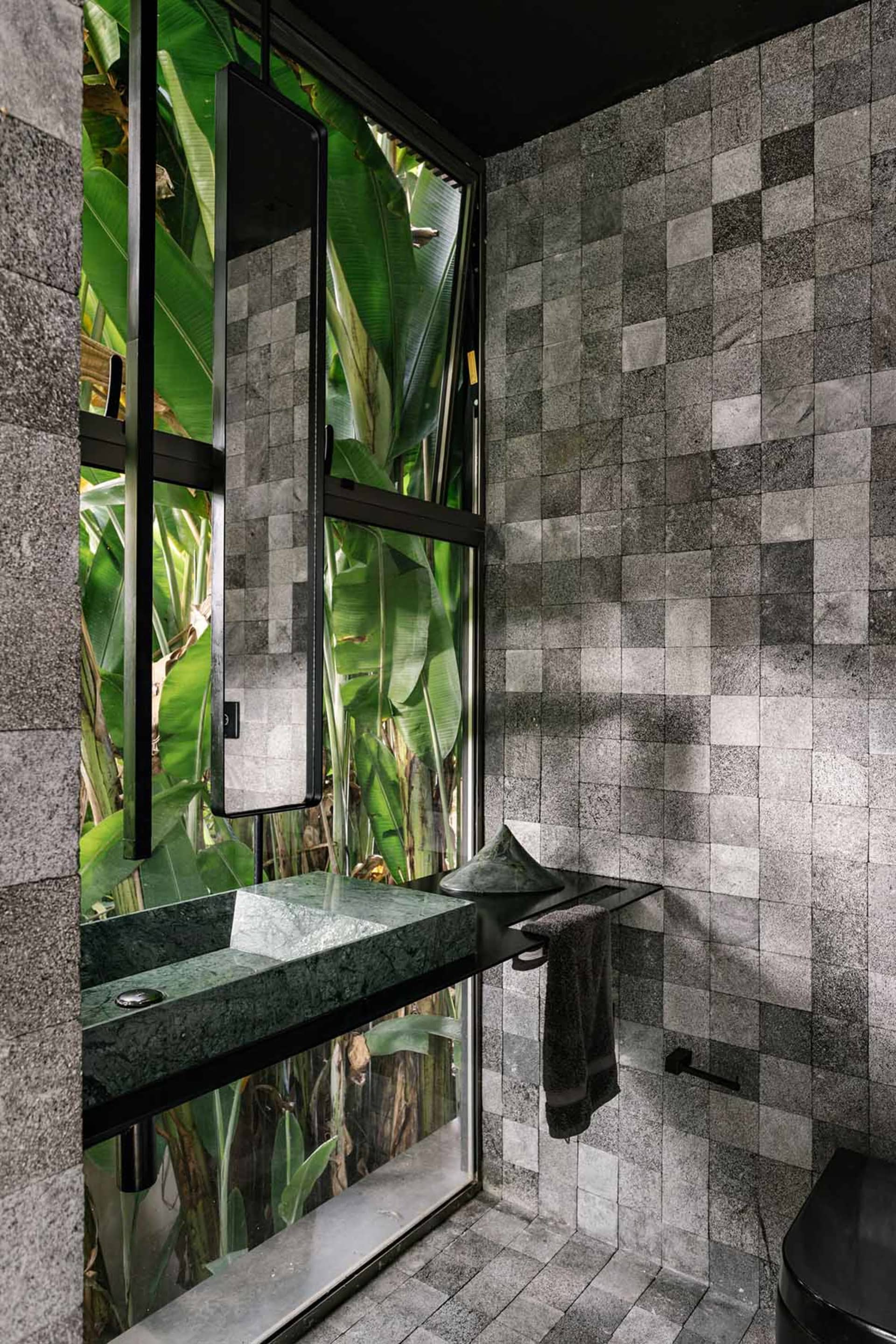 A modern bathroom with industrial design elements and a granite interior.