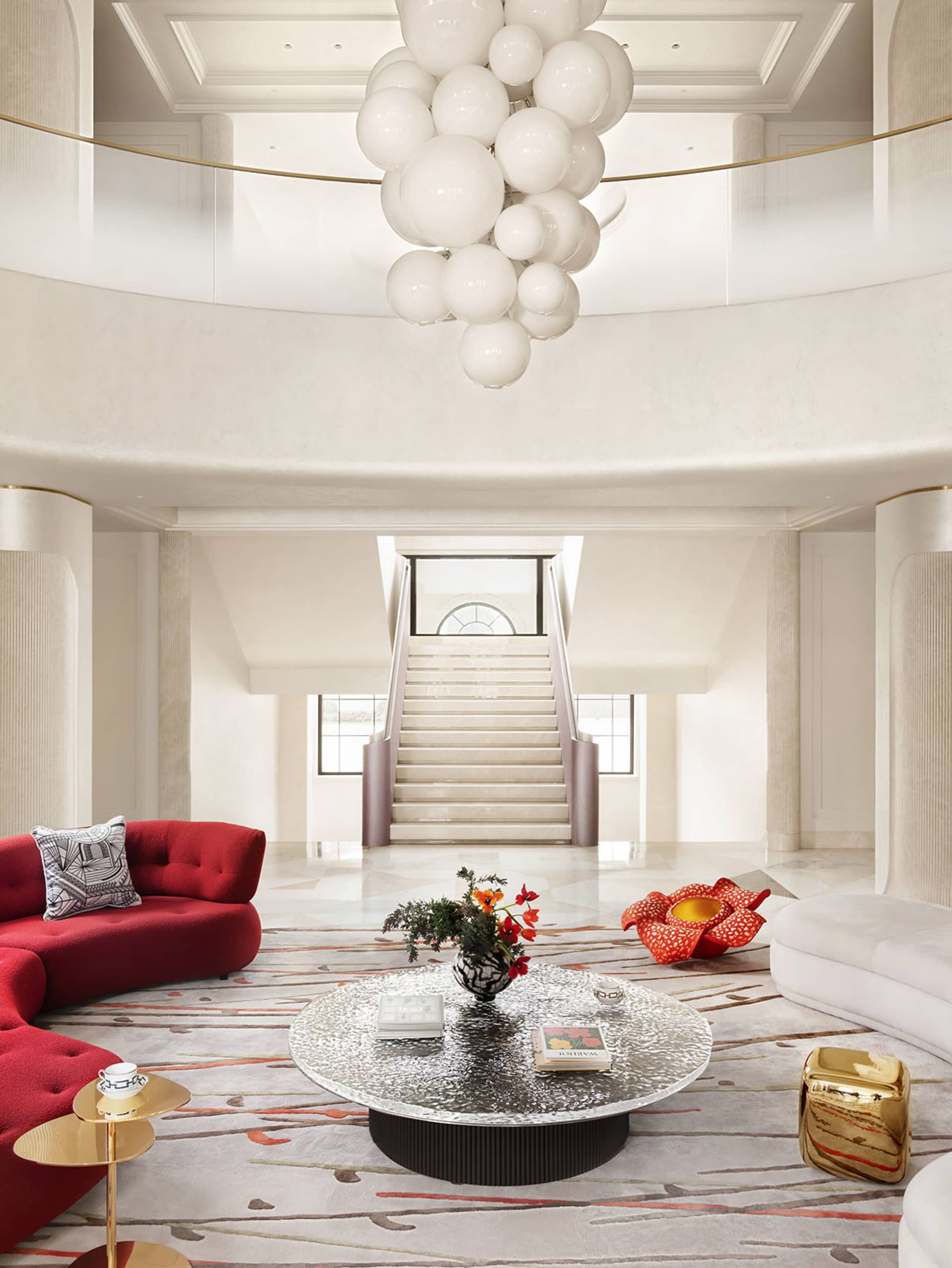 Modern lobby interior with white lighting, red sofas, and white carpet