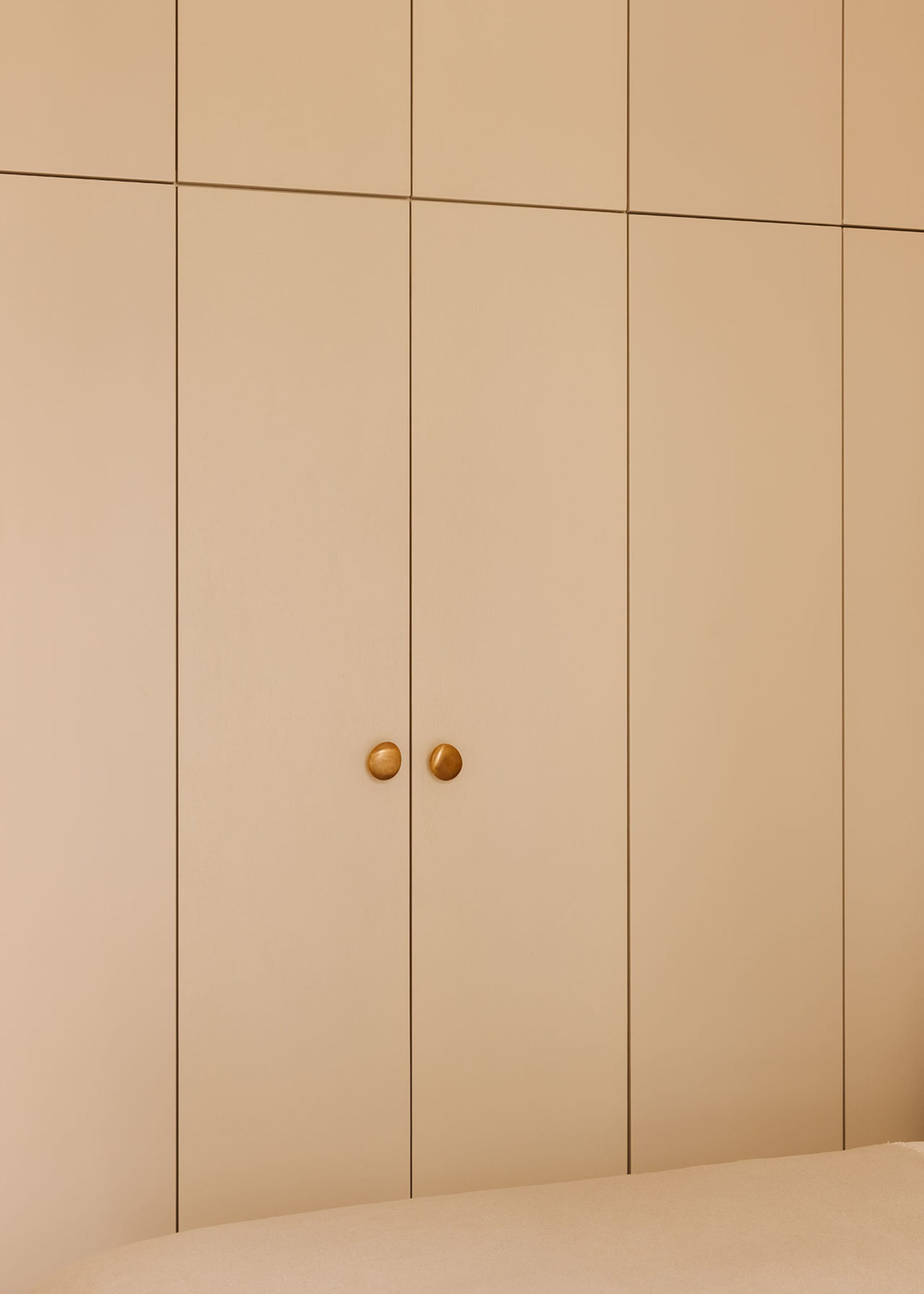 A modern, minimalist wardrobe with neutral colors and simple, elegant design.