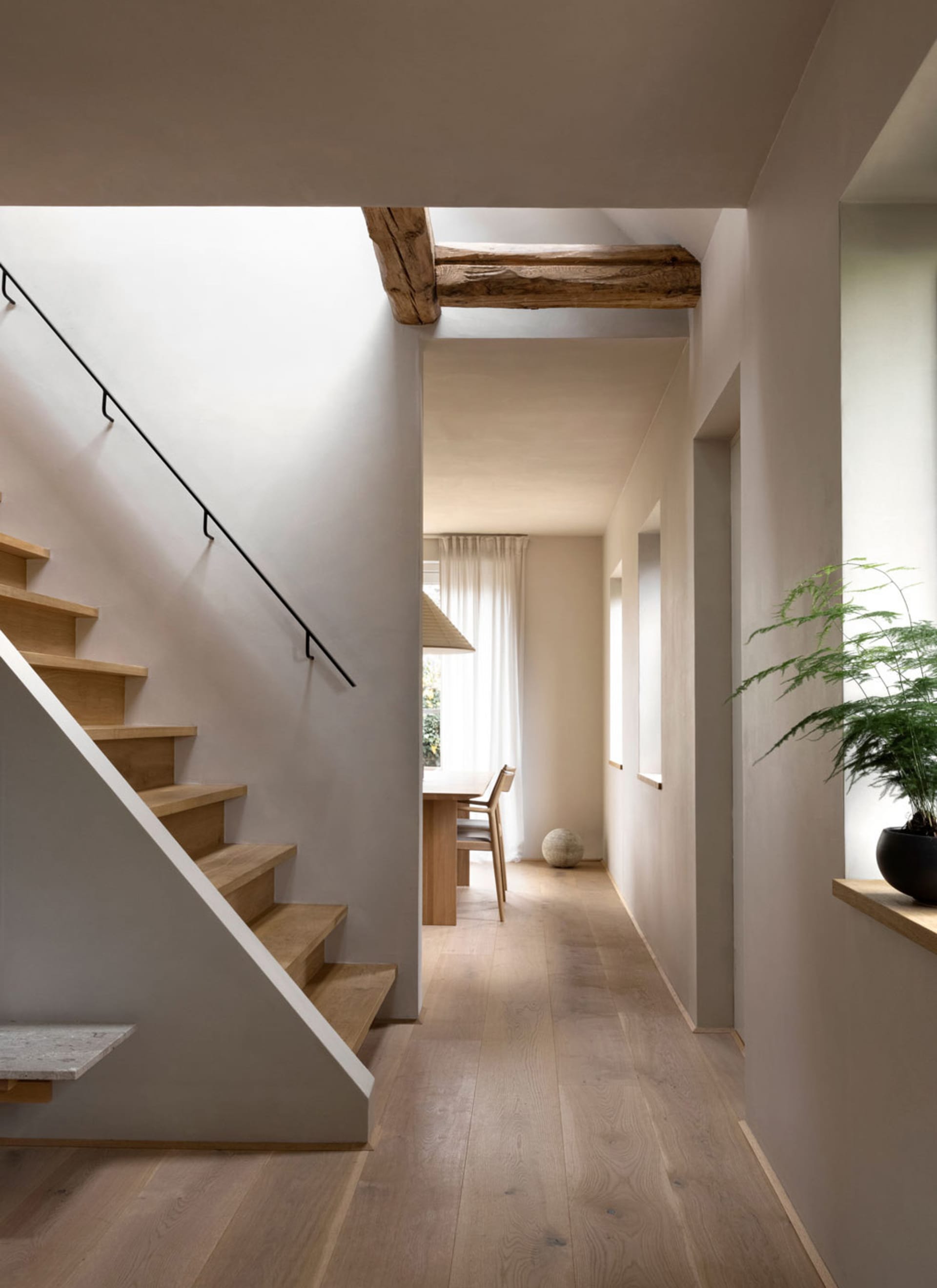A modern interior design featuring hardwood flooring and minimalistic decor.