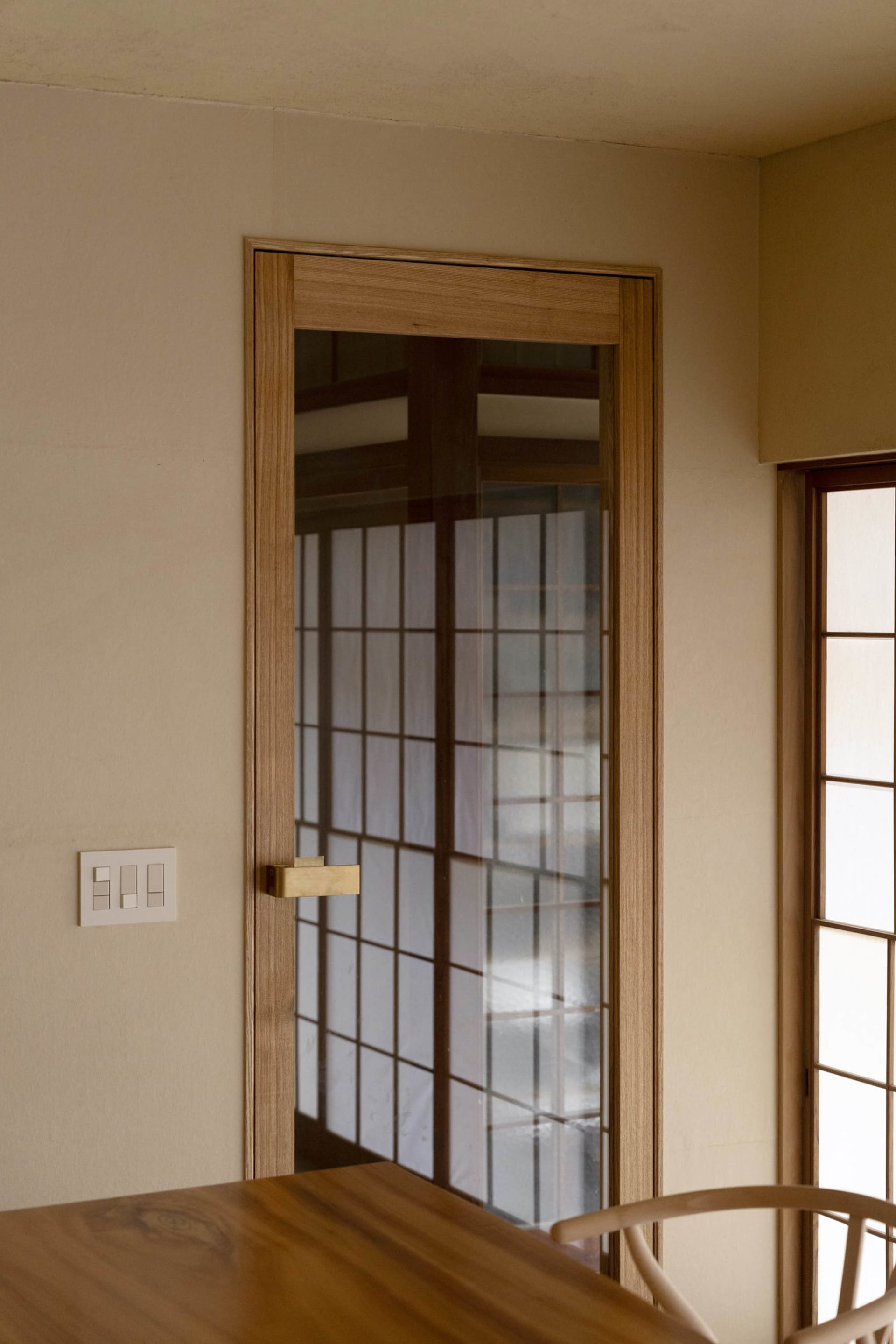 A modern kitchen with a wooden frame and glass door.