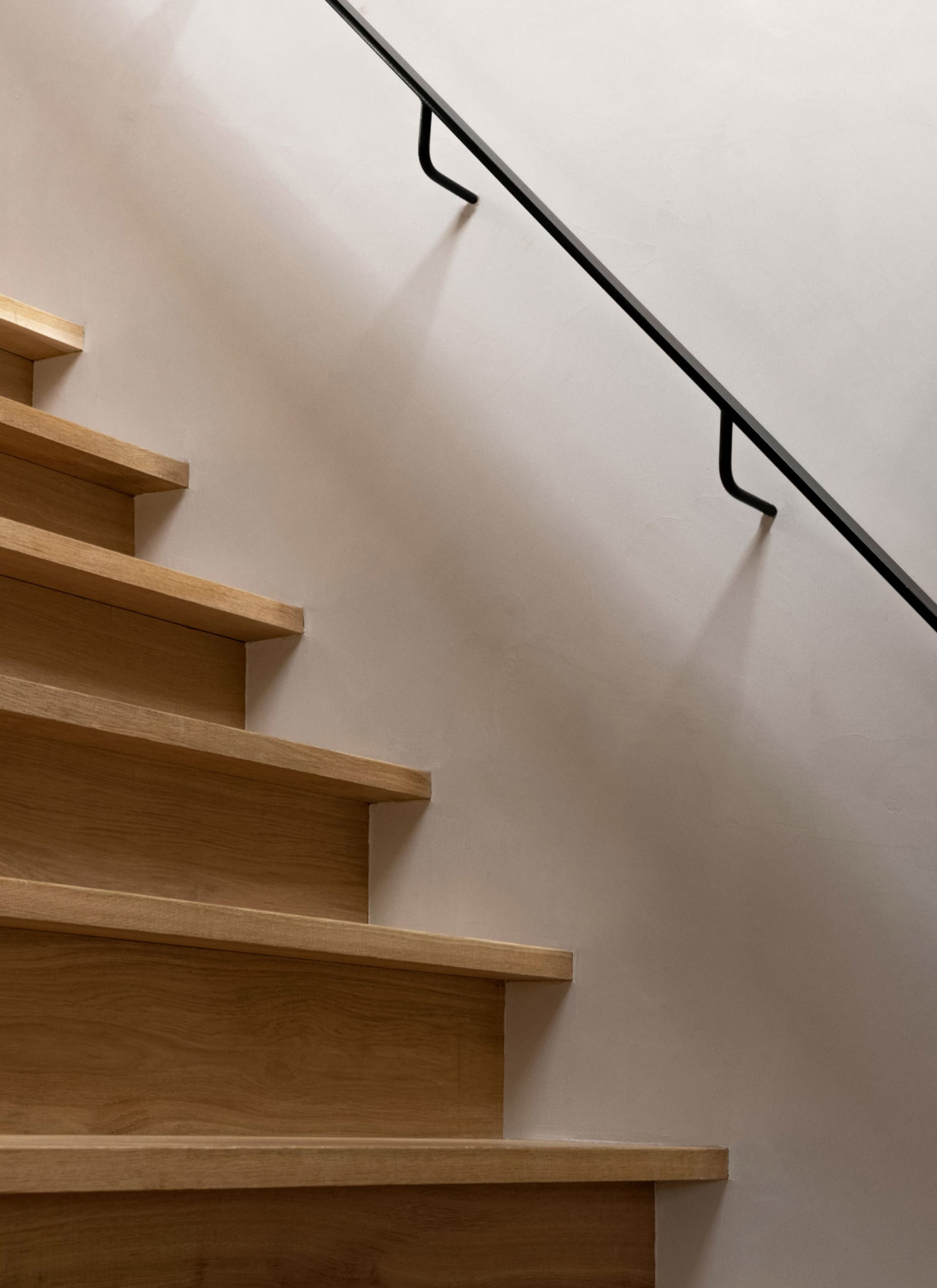 Modern wooden staircase featuring sleek, minimalist design elements.