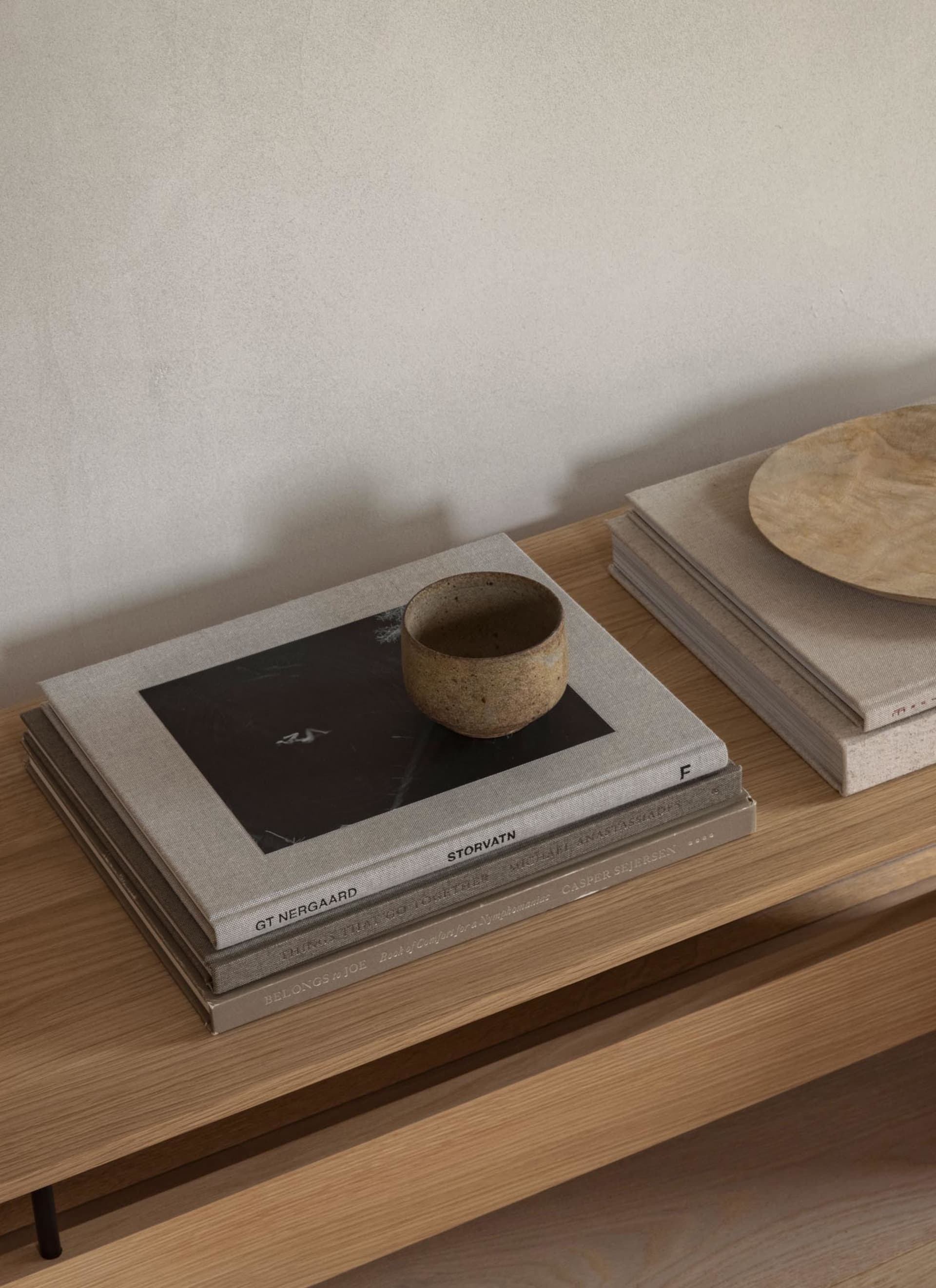 A minimalist home with a ceramic cup placed on cork surfaces.