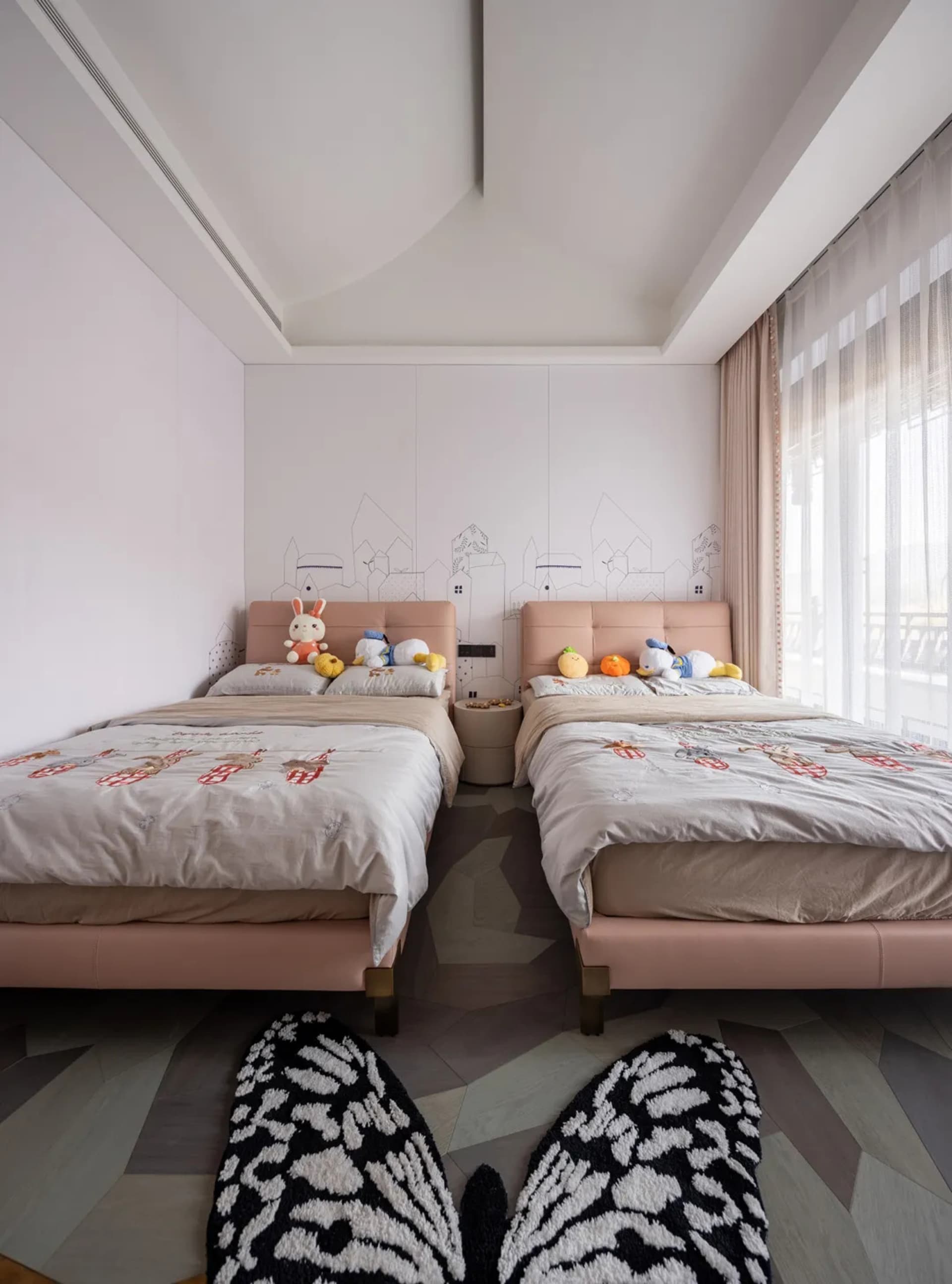 comfortable twin beds with light-colored fabric headboards in a modern bedroom setting