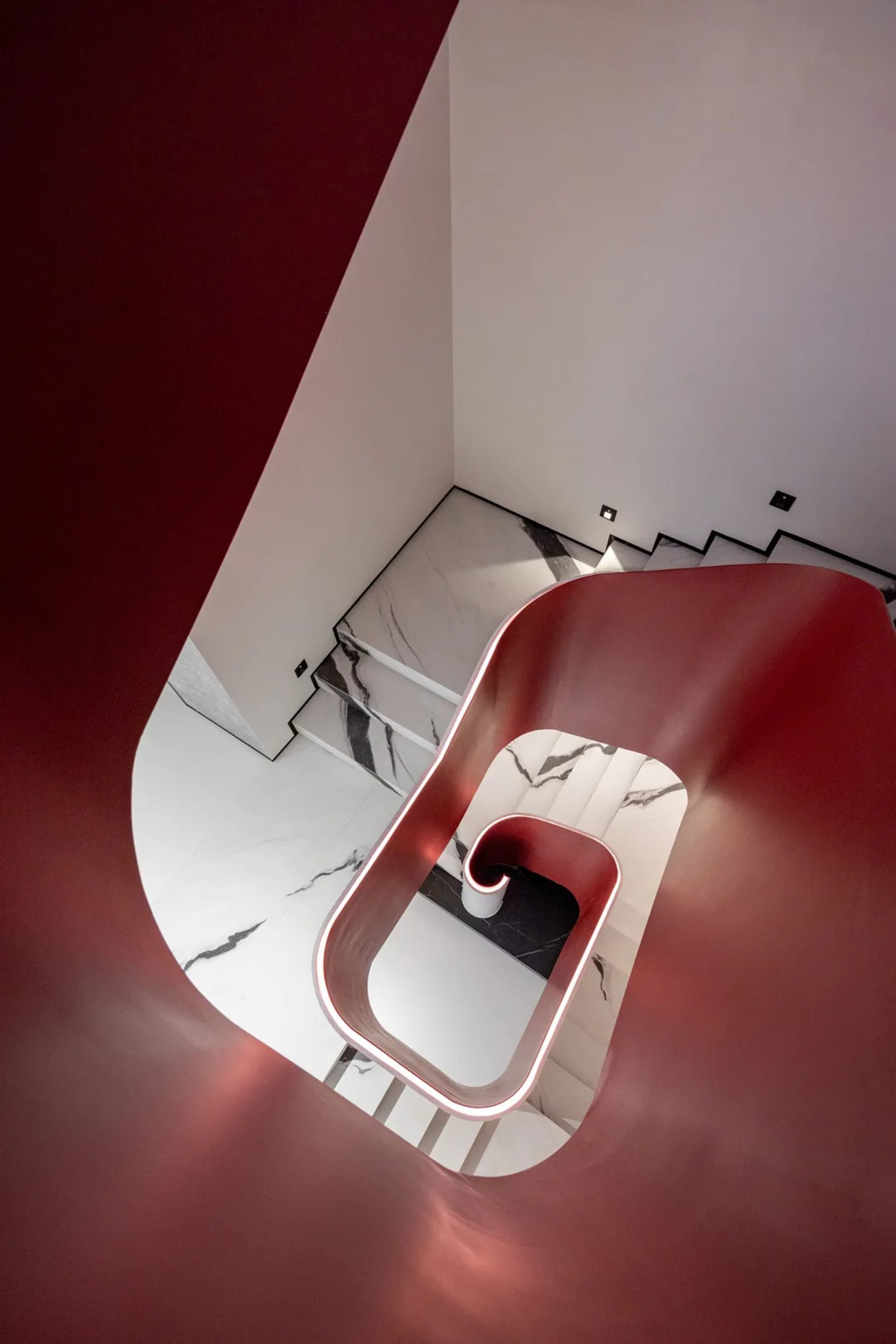 Modern interior with marble stairs, white walls, and black accents.
