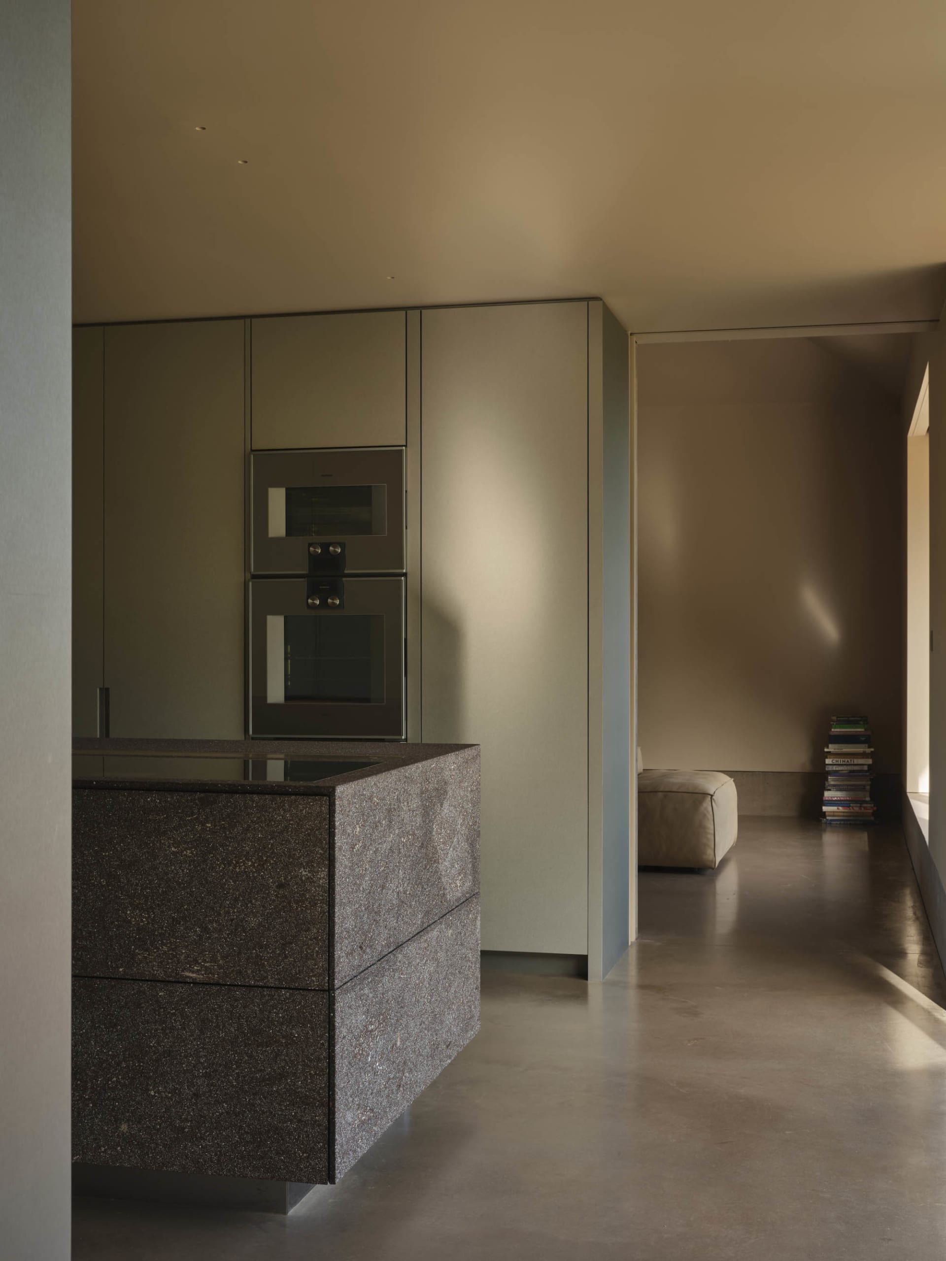 Minimalist kitchen featuring marble countertops and sleek, modern appliances.