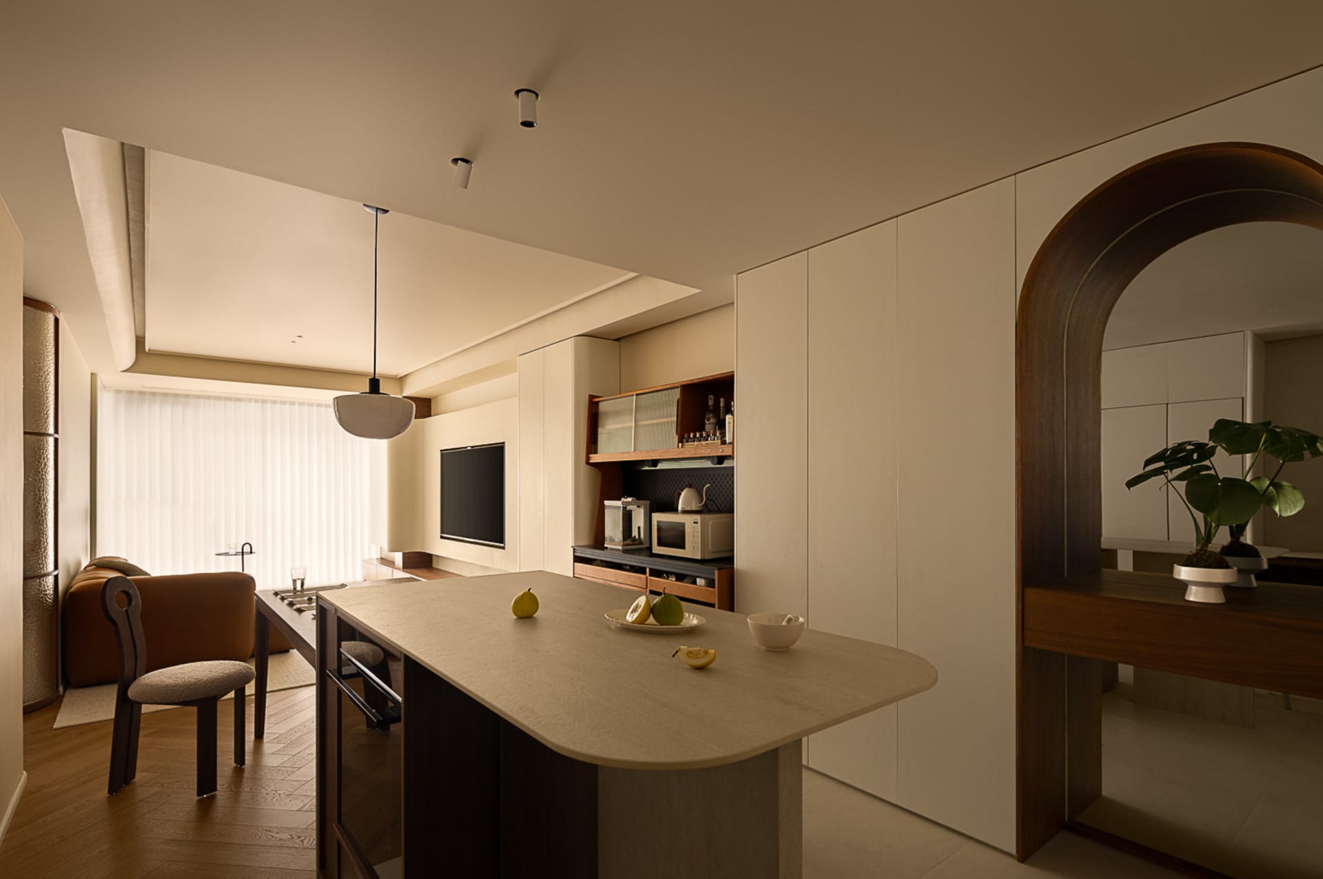 A minimalist kitchen with a marble countertop and wooden fixtures, featuring a glass backsplash and modern appliances.