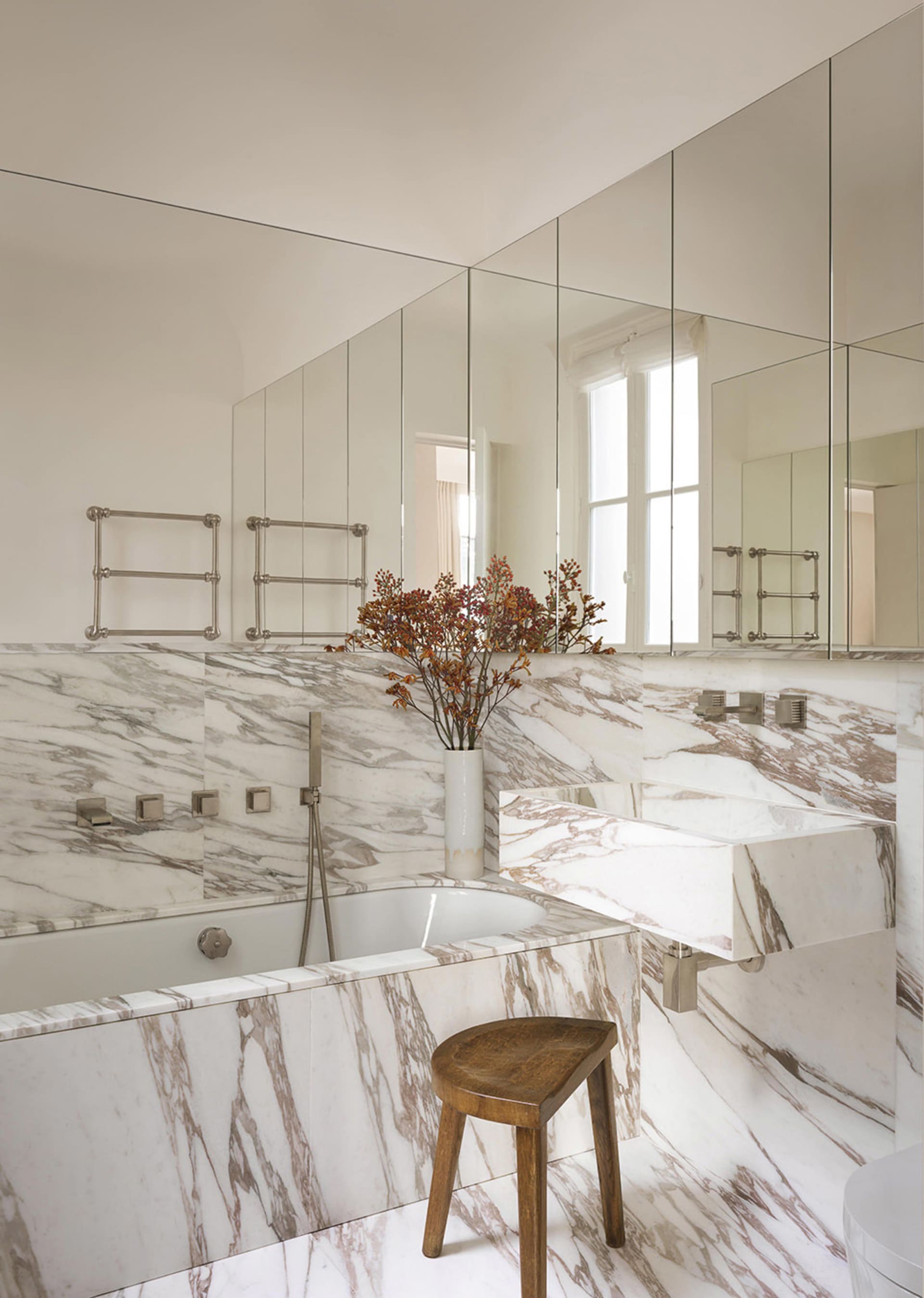 A modern bathroom featuring marble accents and fixtures.