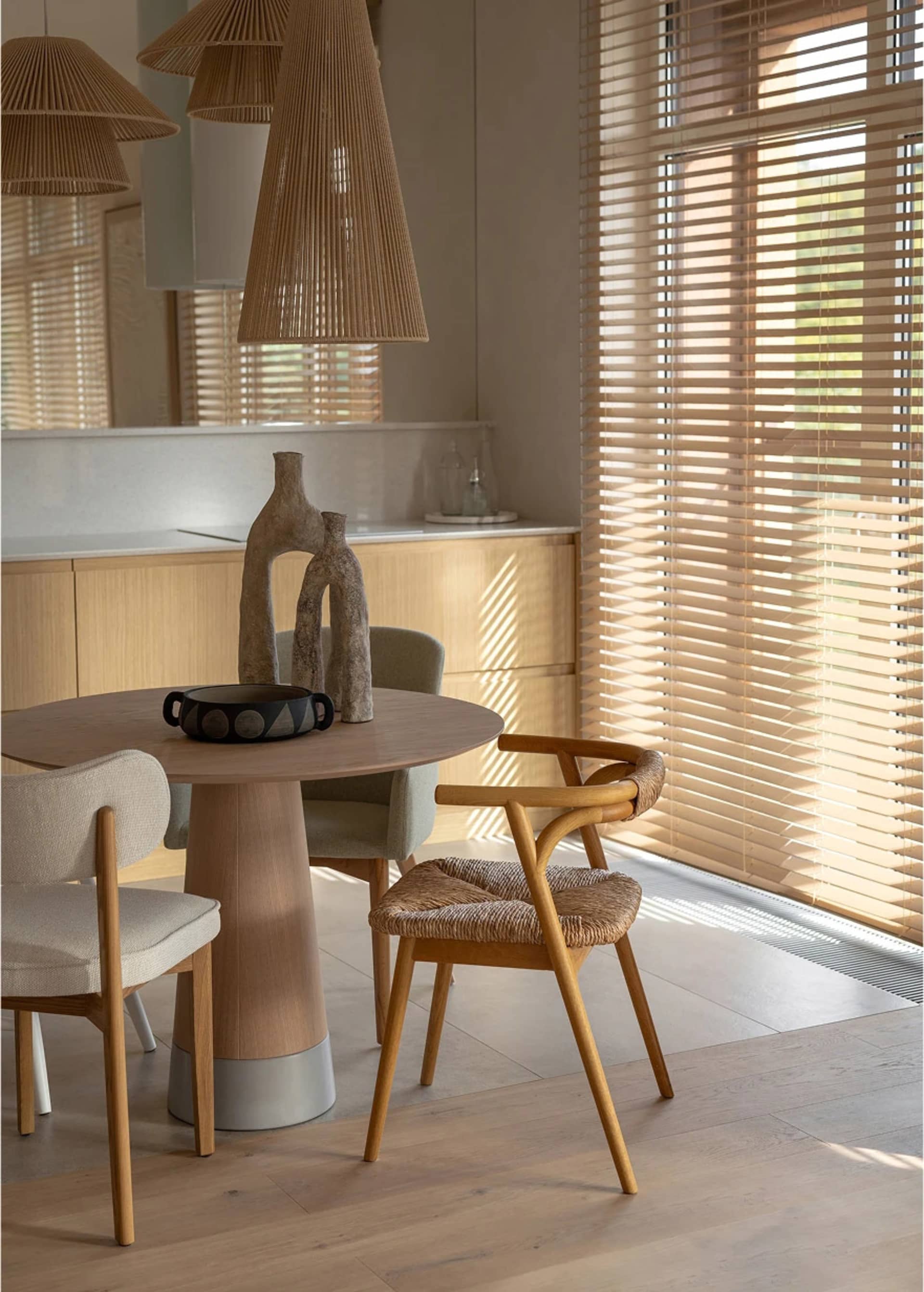 Modern kitchen with woven chairs and wooden furniture