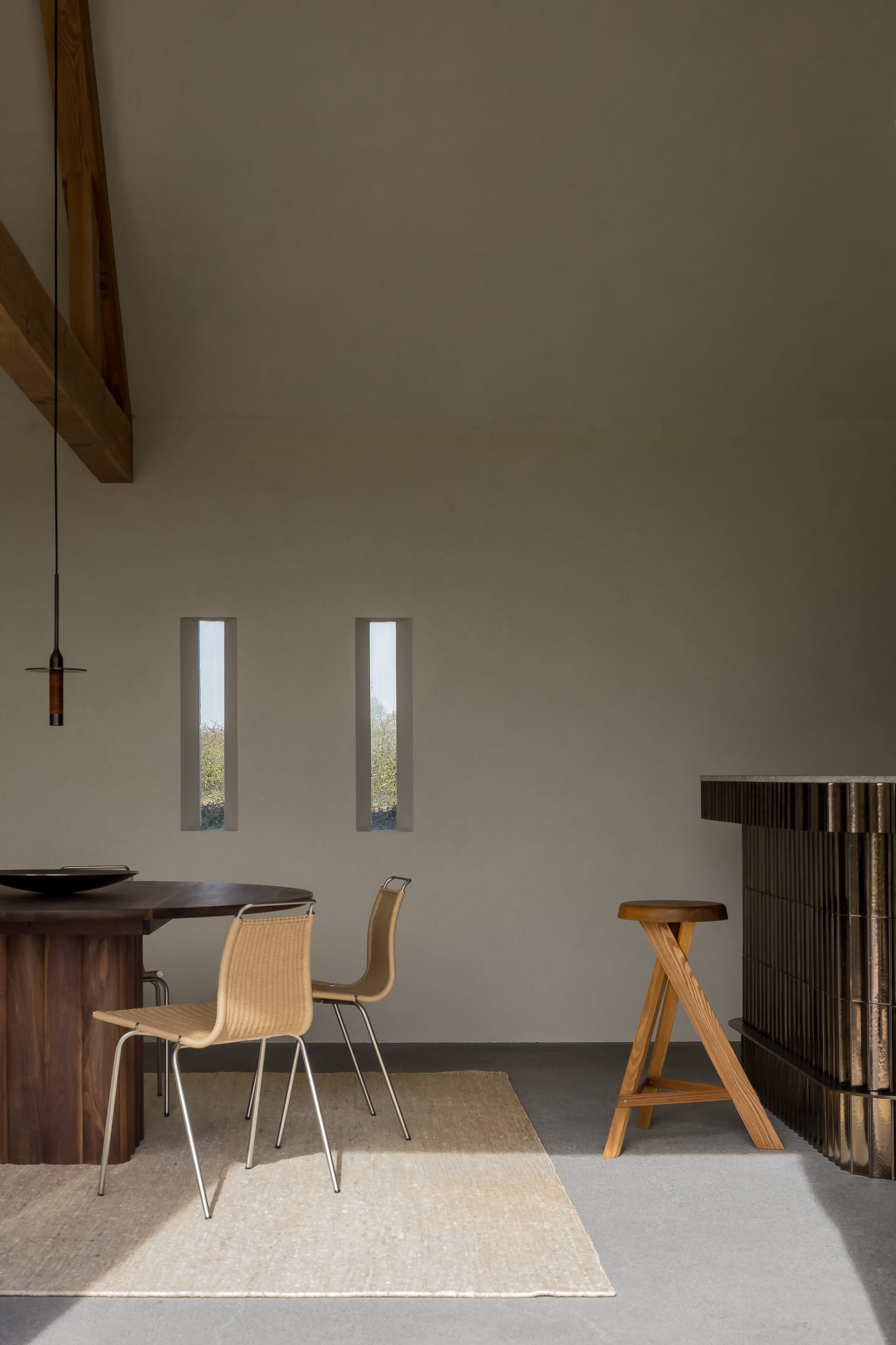 Industrial-style dining room featuring wooden furniture and a minimalist design.