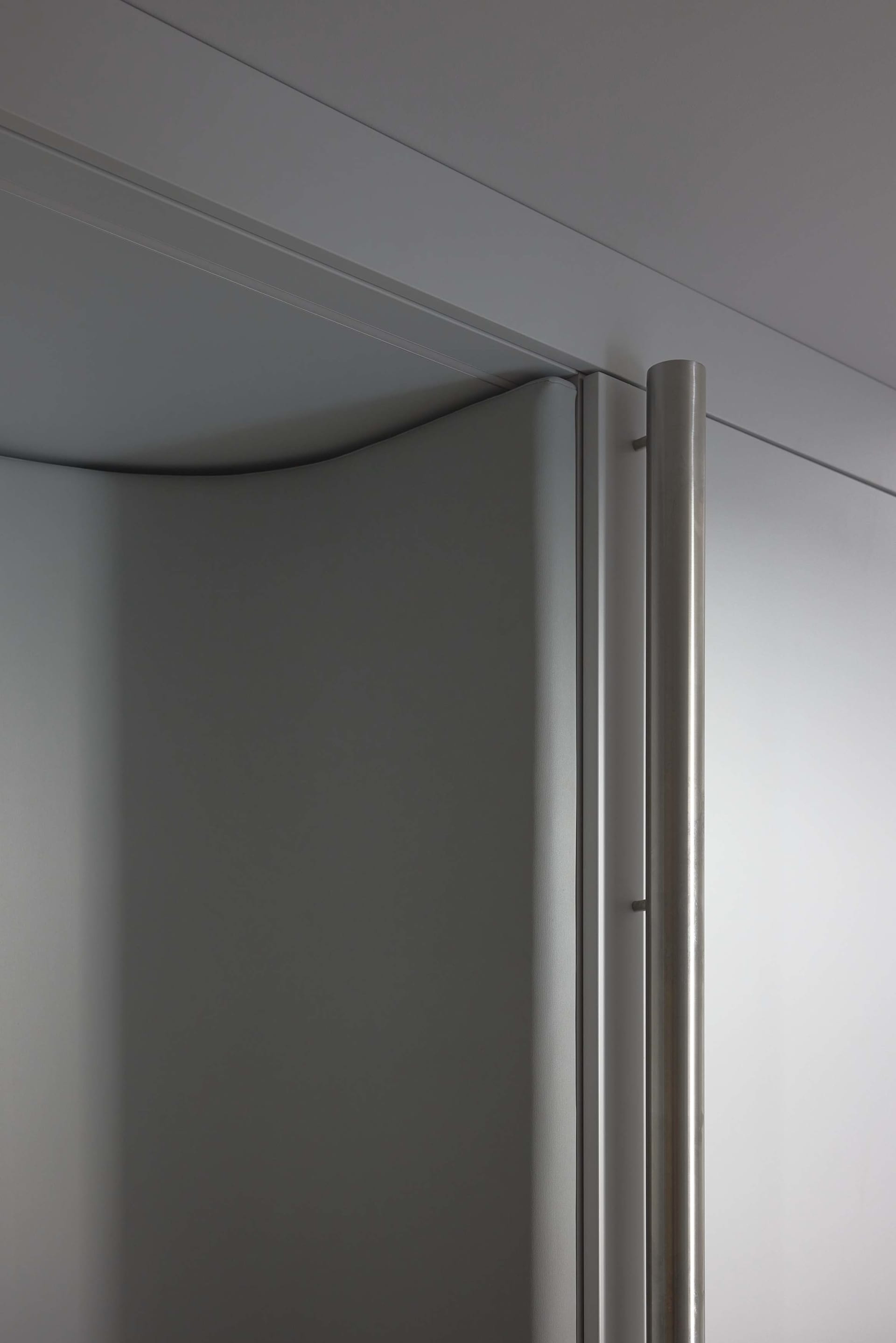 Modern industrial-style closet with metallic grey paneling and sleek, minimalist design.
