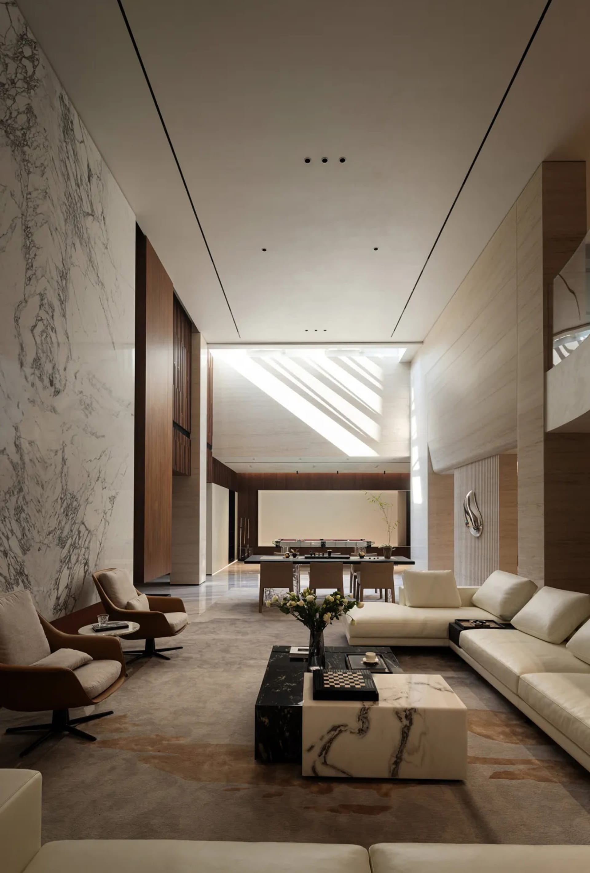 A modern living room features a marble wall and white leather furniture, providing a luxurious and contemporary space.
