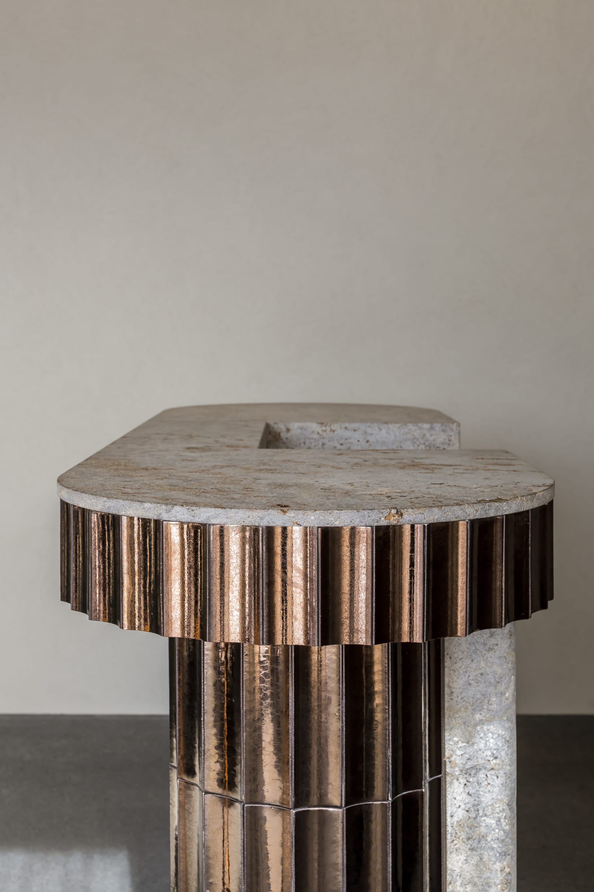 Close-up of a modern metal table with a stone top.