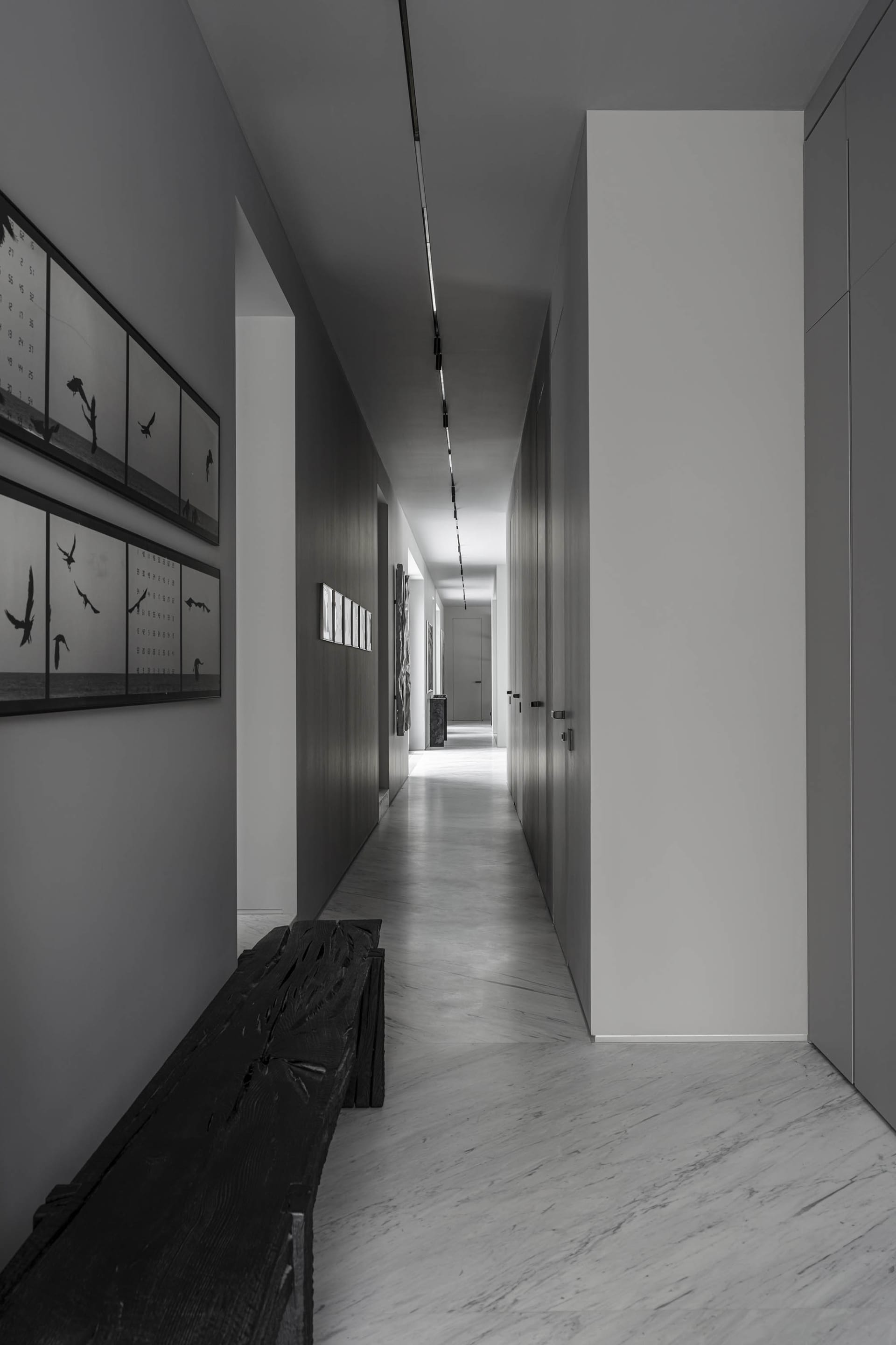 A minimalist corridor with concrete walls and flooring.