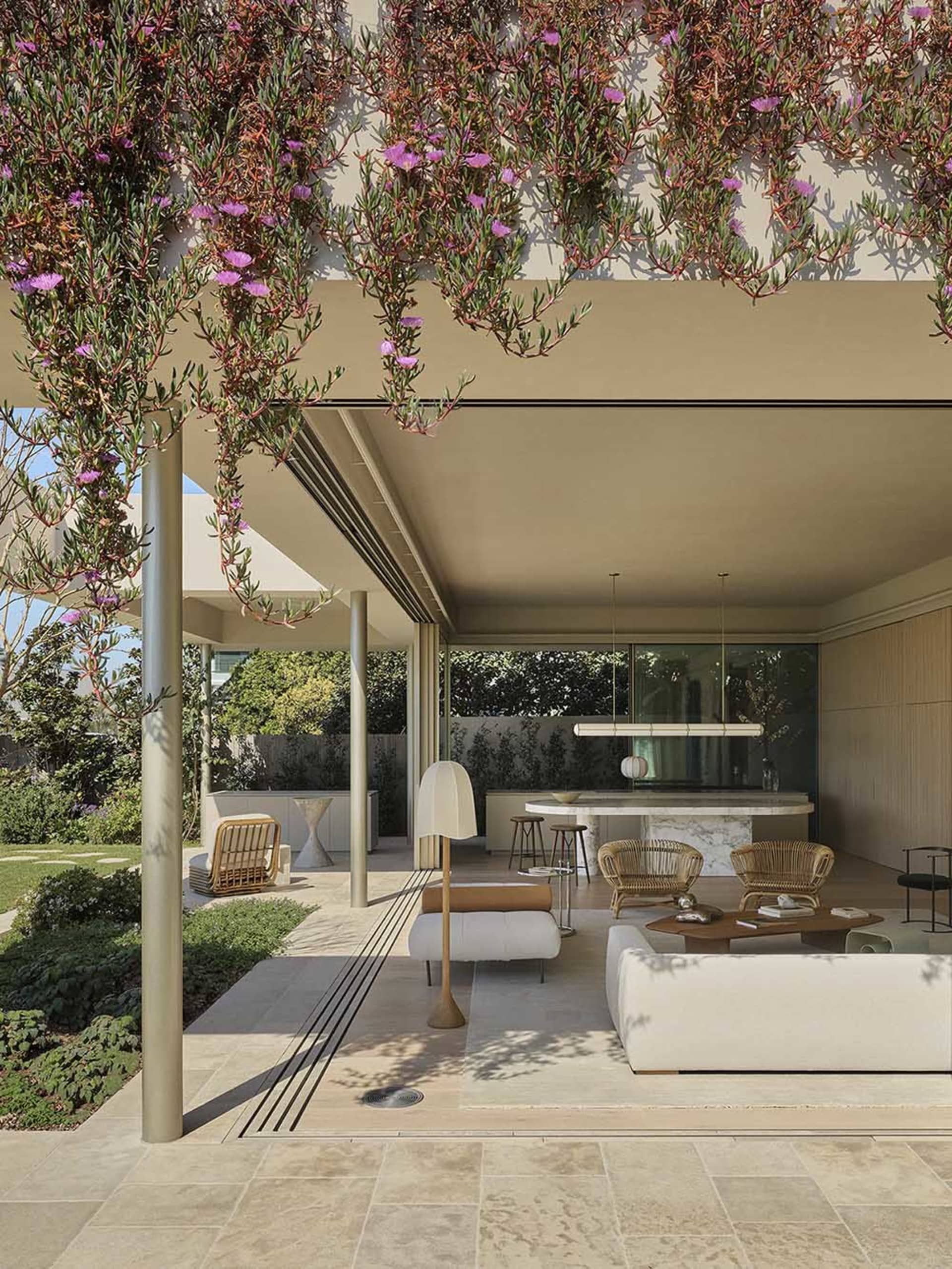 A minimalist patio with concrete, wood, and natural stone materials.