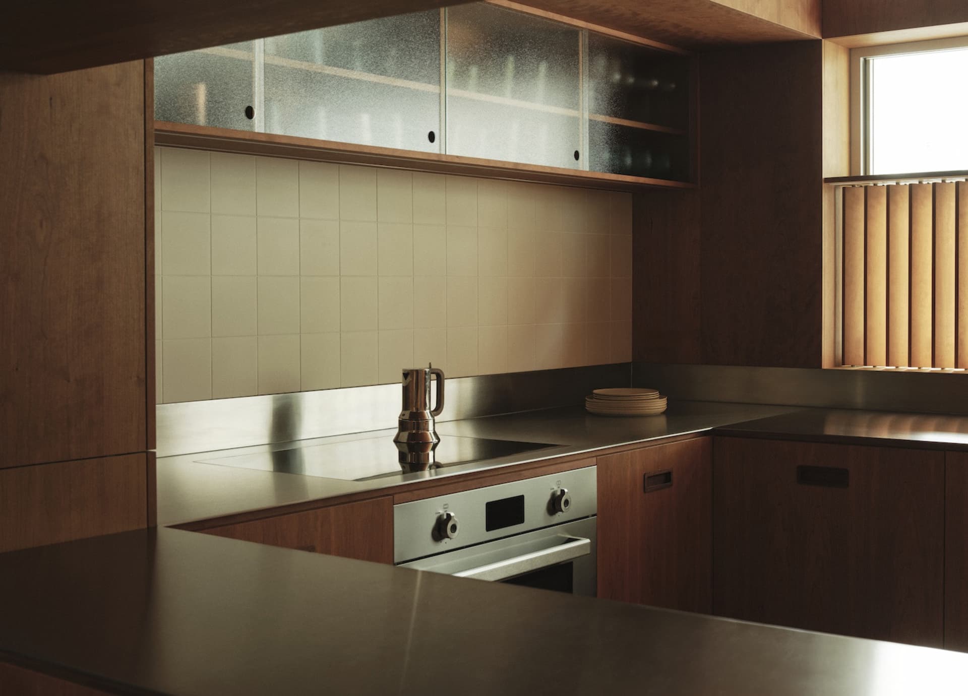 A modern kitchen with wooden countertops and tiled backsplash.