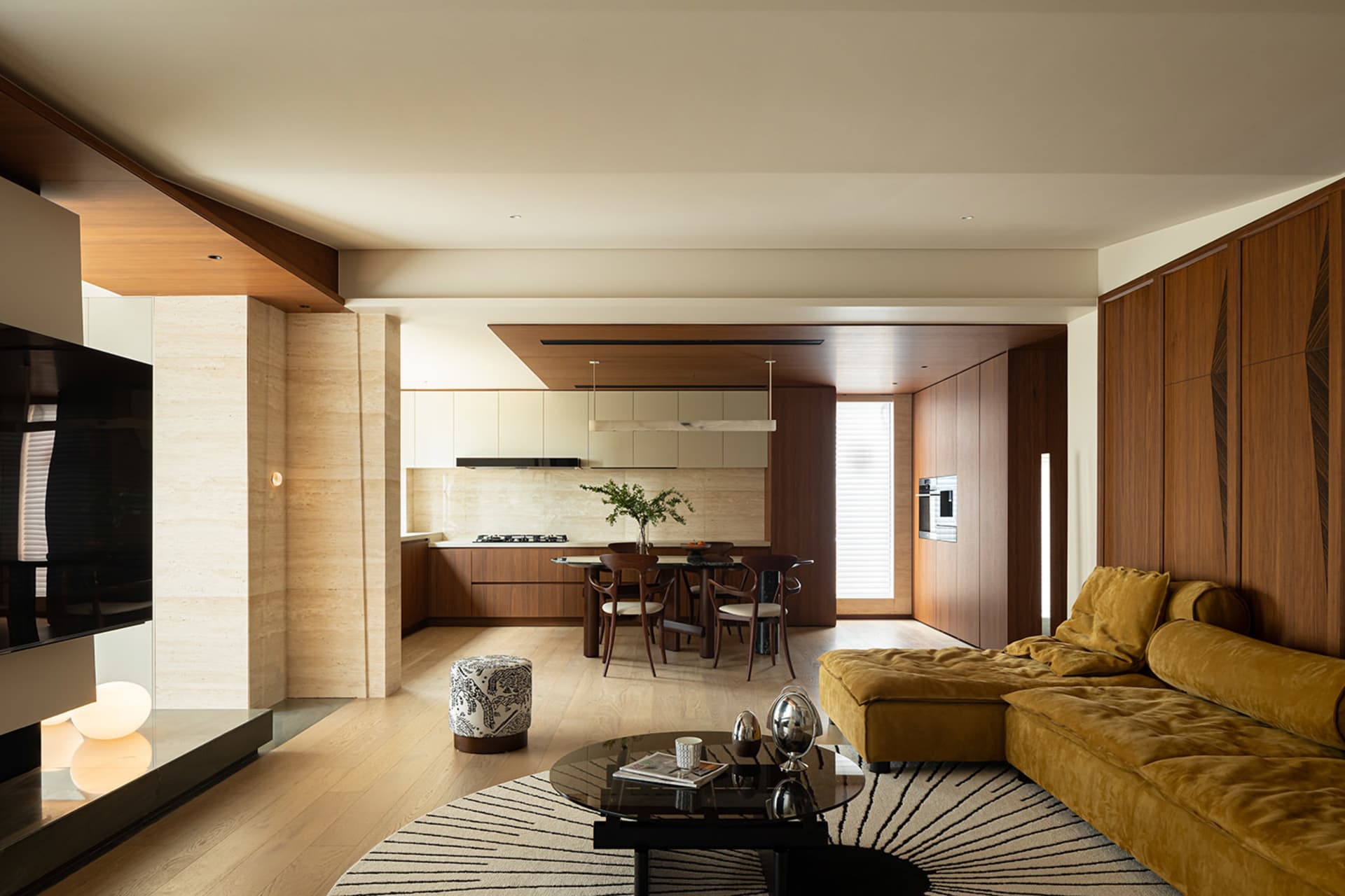 A modern living room featuring wooden flooring, a yellow sectional sofa, and a coffee table.