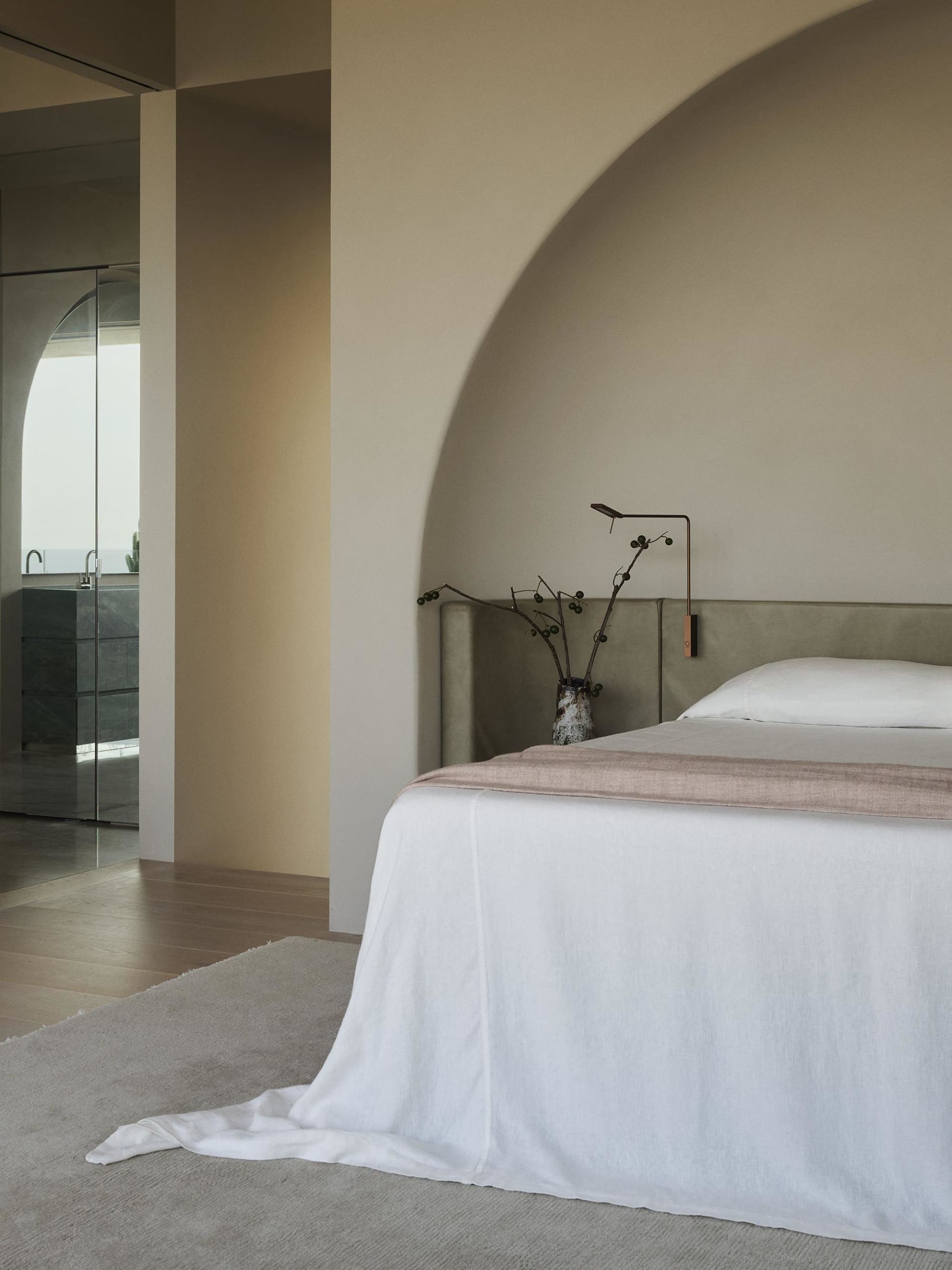 A modern bathroom with concrete tiles, featuring a walk-in shower and white accents.