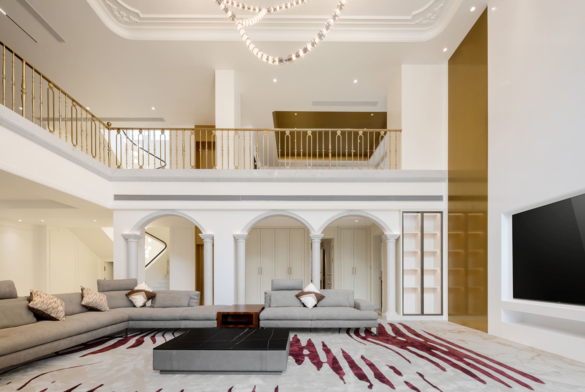 Modern living room with marble floor, leather sofas, and glass features