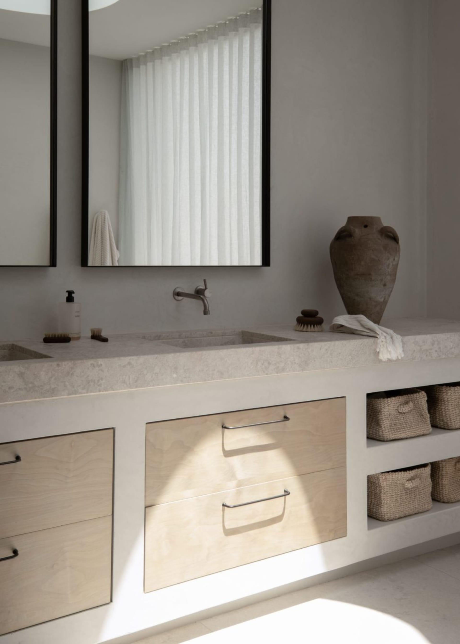Modern bathroom renovation featuring a minimalist concrete countertop with sleek, minimalist design.