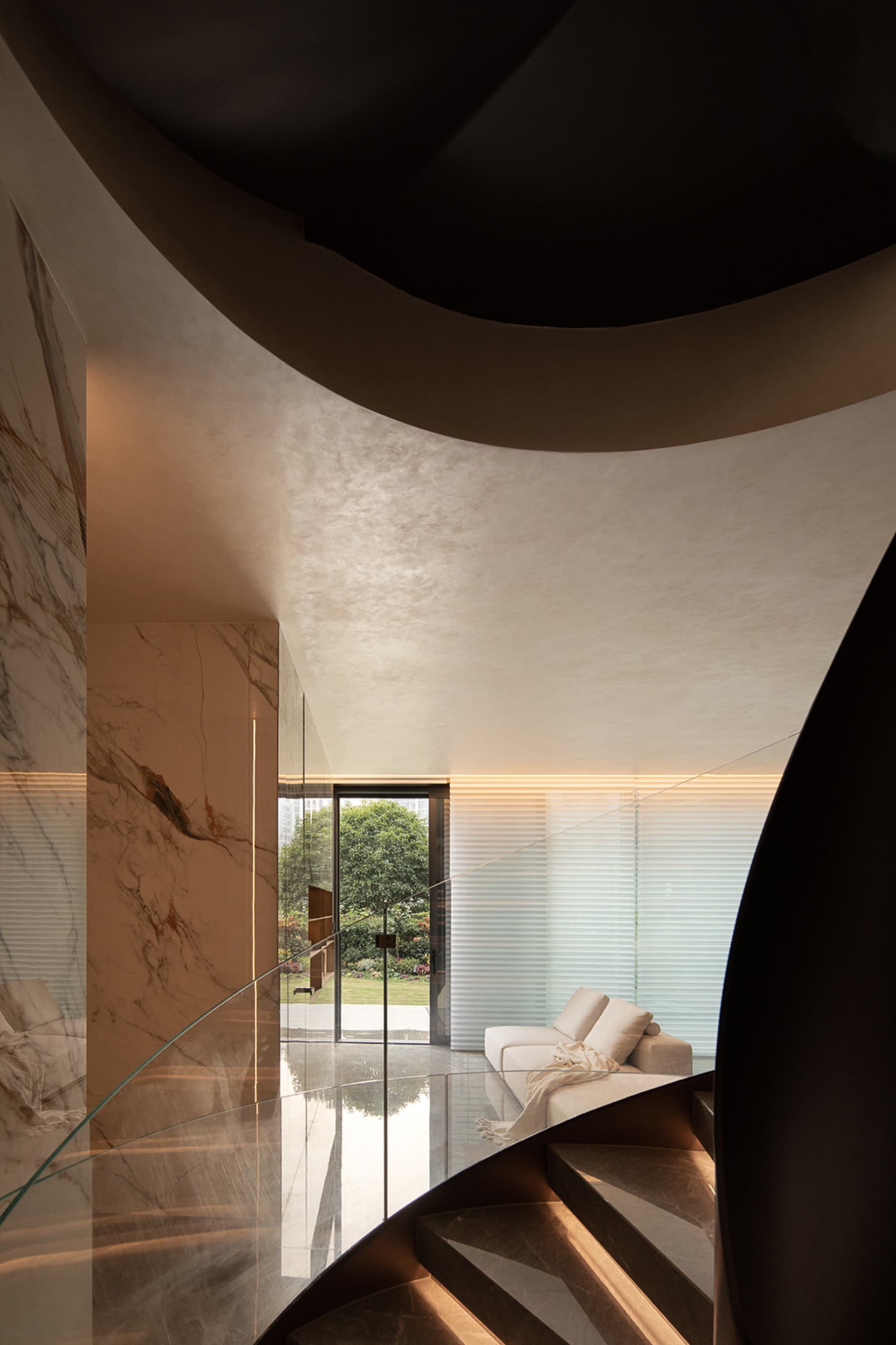 A modern living room with white marble floor, wooden furniture with round and curved legs, and a colorful abstract painting o