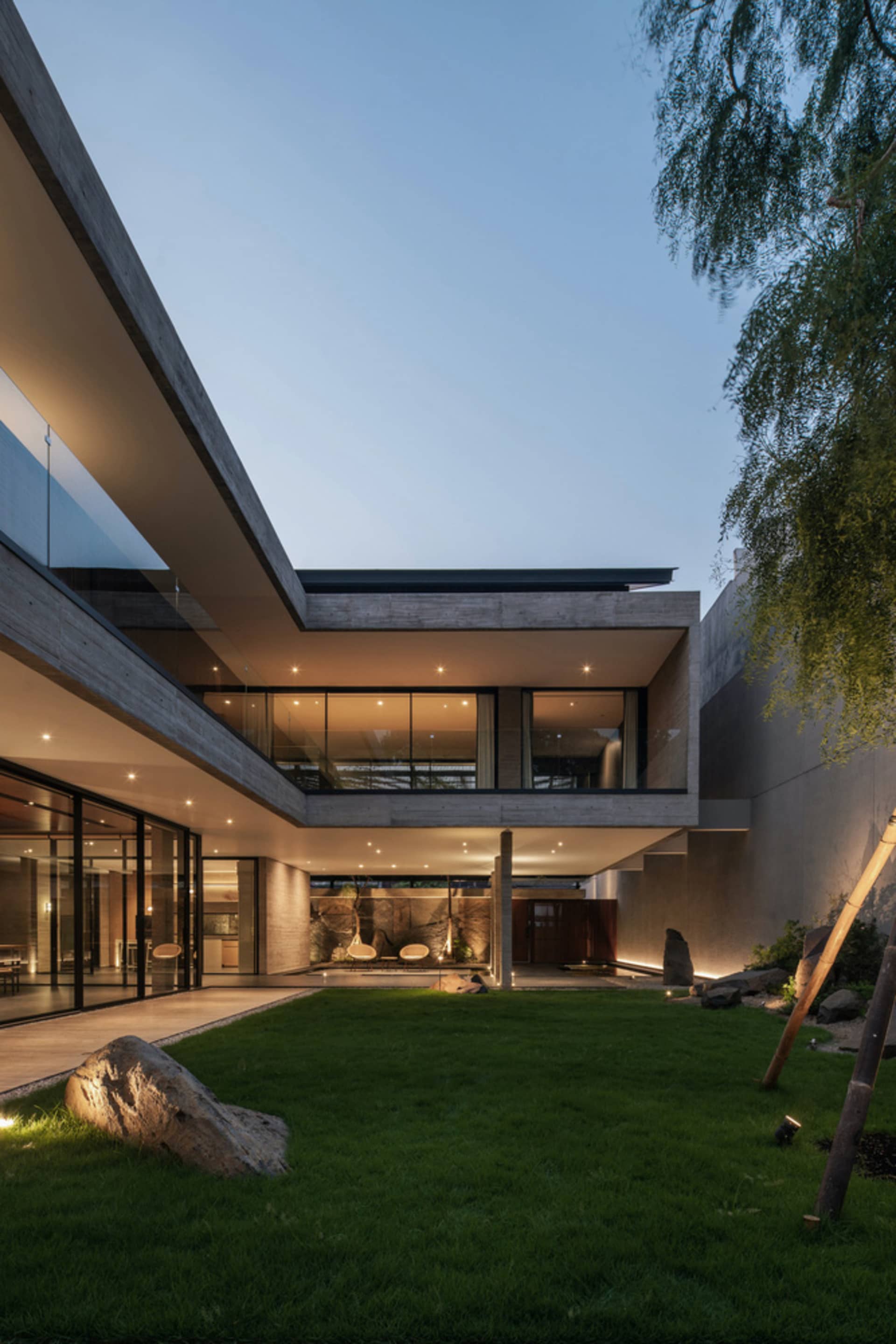 Modern residential house with a minimalist design featuring a concrete exterior and a trellis.