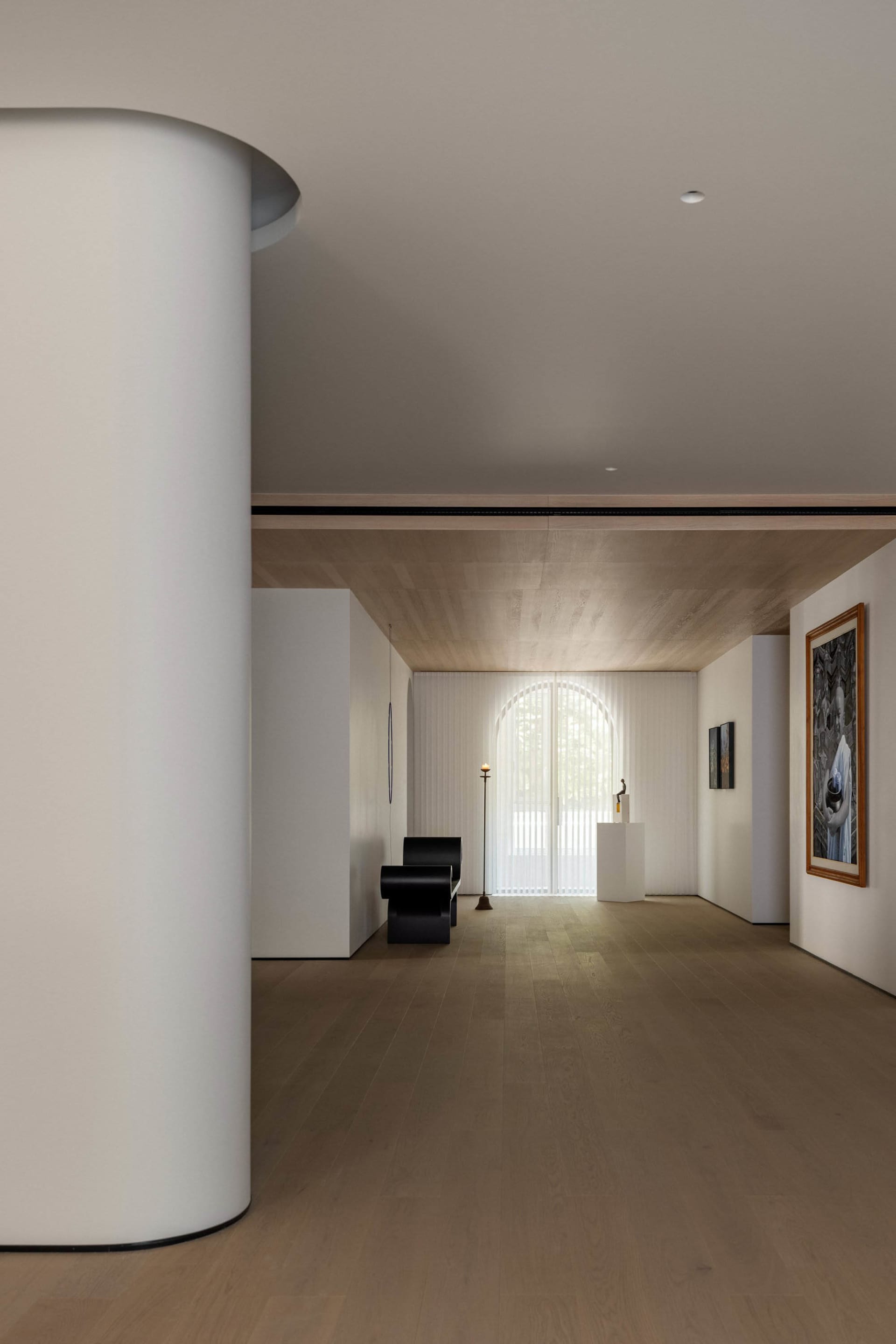 A modern interior with white marble walls and floor, featuring minimalist decor and a sleek, contemporary design.