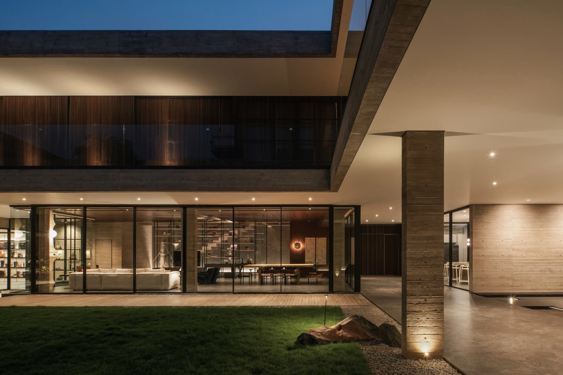 Modern minimalist residential home with concrete, glass, and wooden materials.