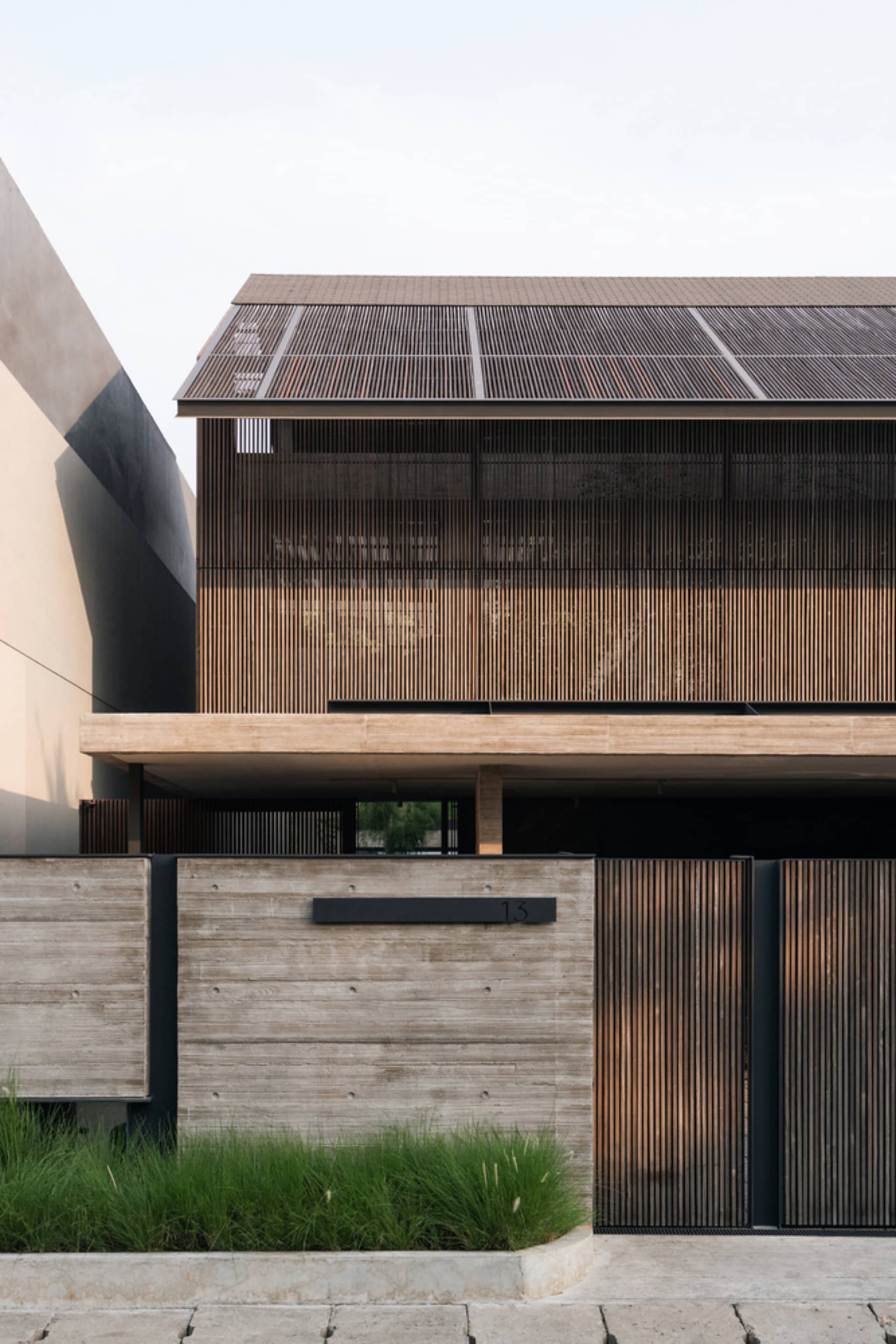 Modern building exterior featuring wood and concrete materials.