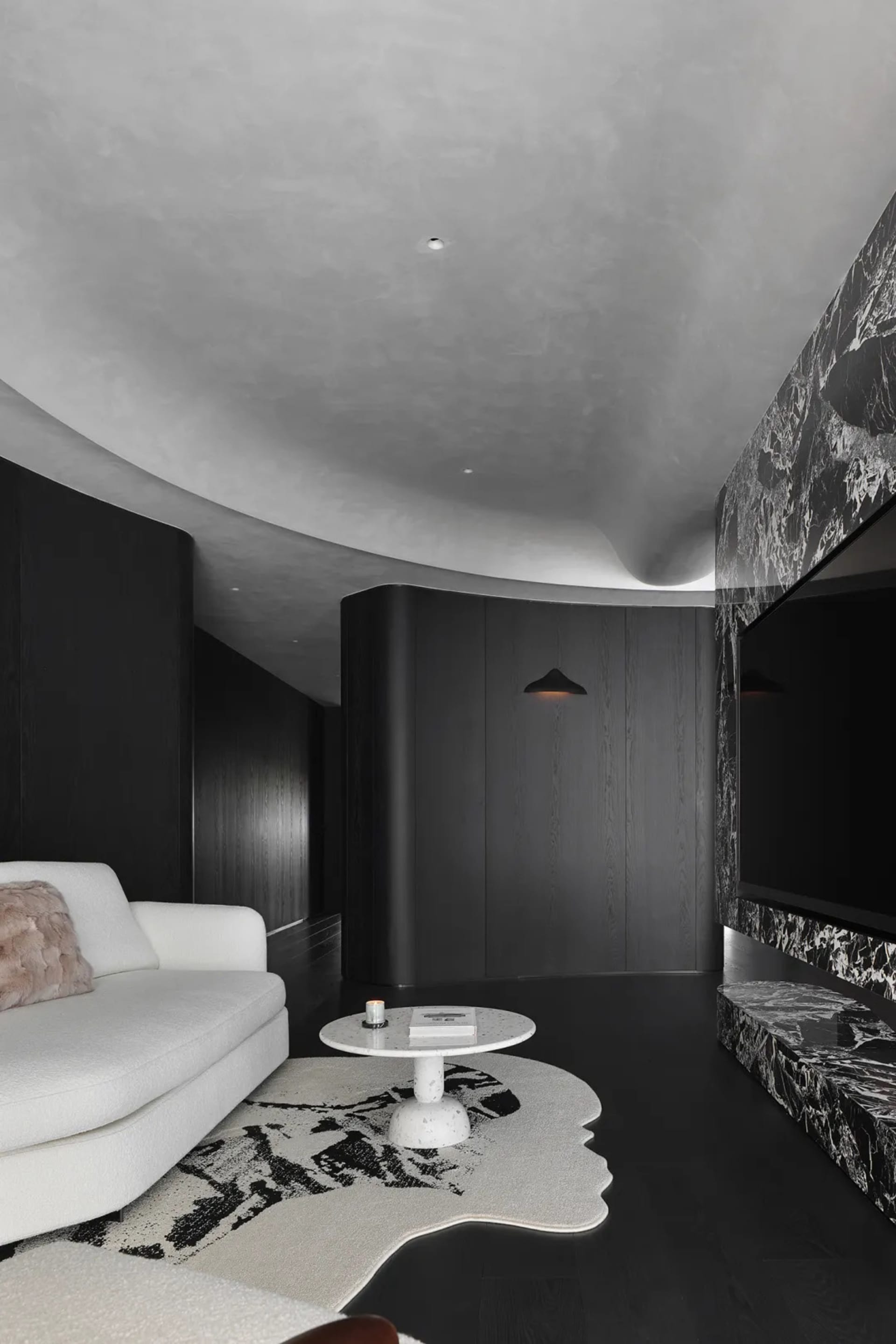 Modern living room featuring marble accents and wooden elements
