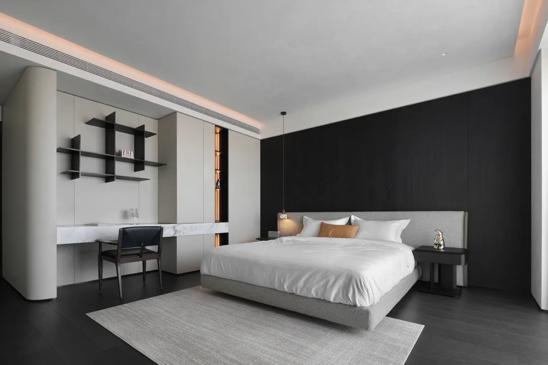 A minimalist bedroom with a bed, side table, and open closet.