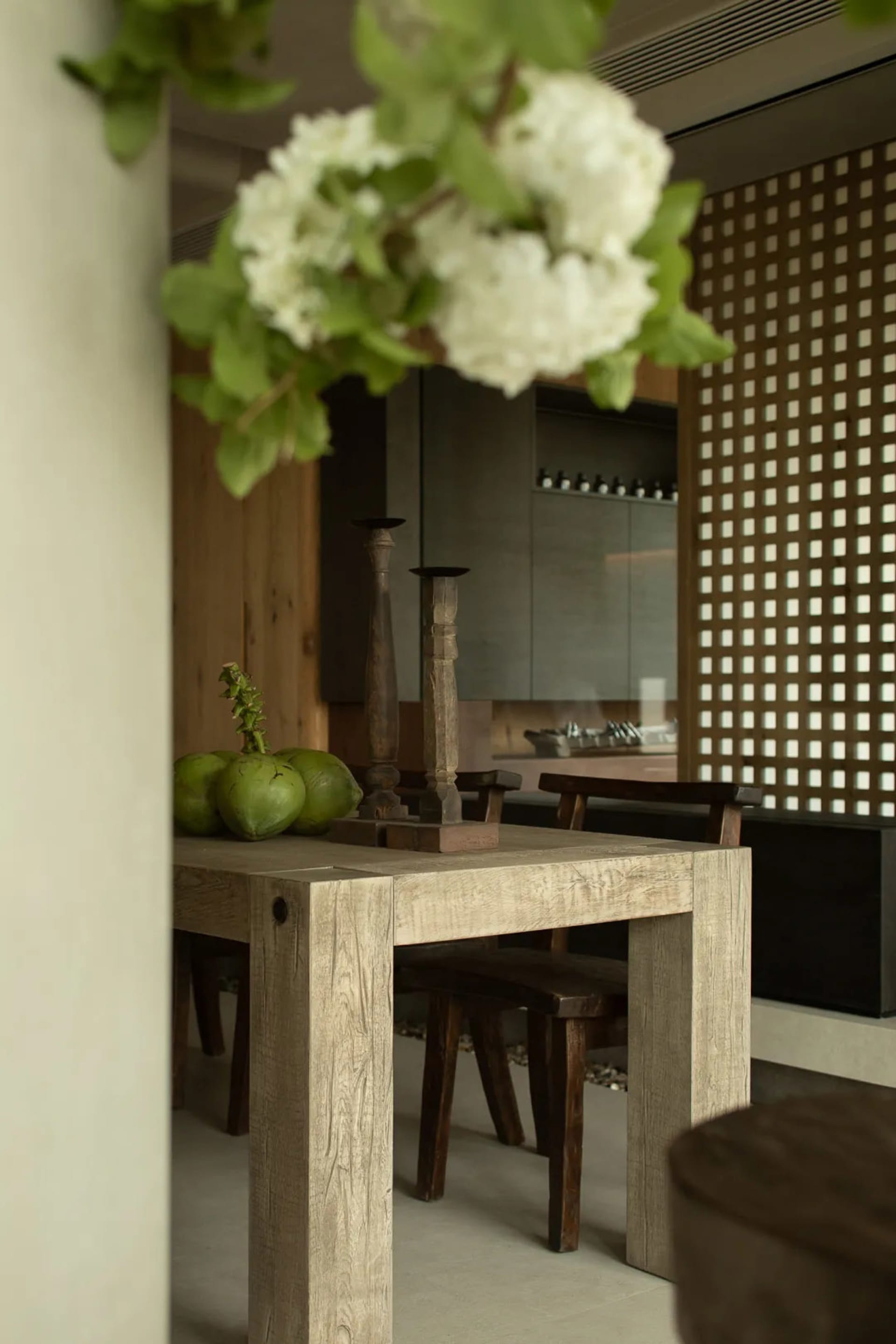 Modern dining room with wooden table and stone surface, featuring modern decor elements like wooden chairs and minimalist des