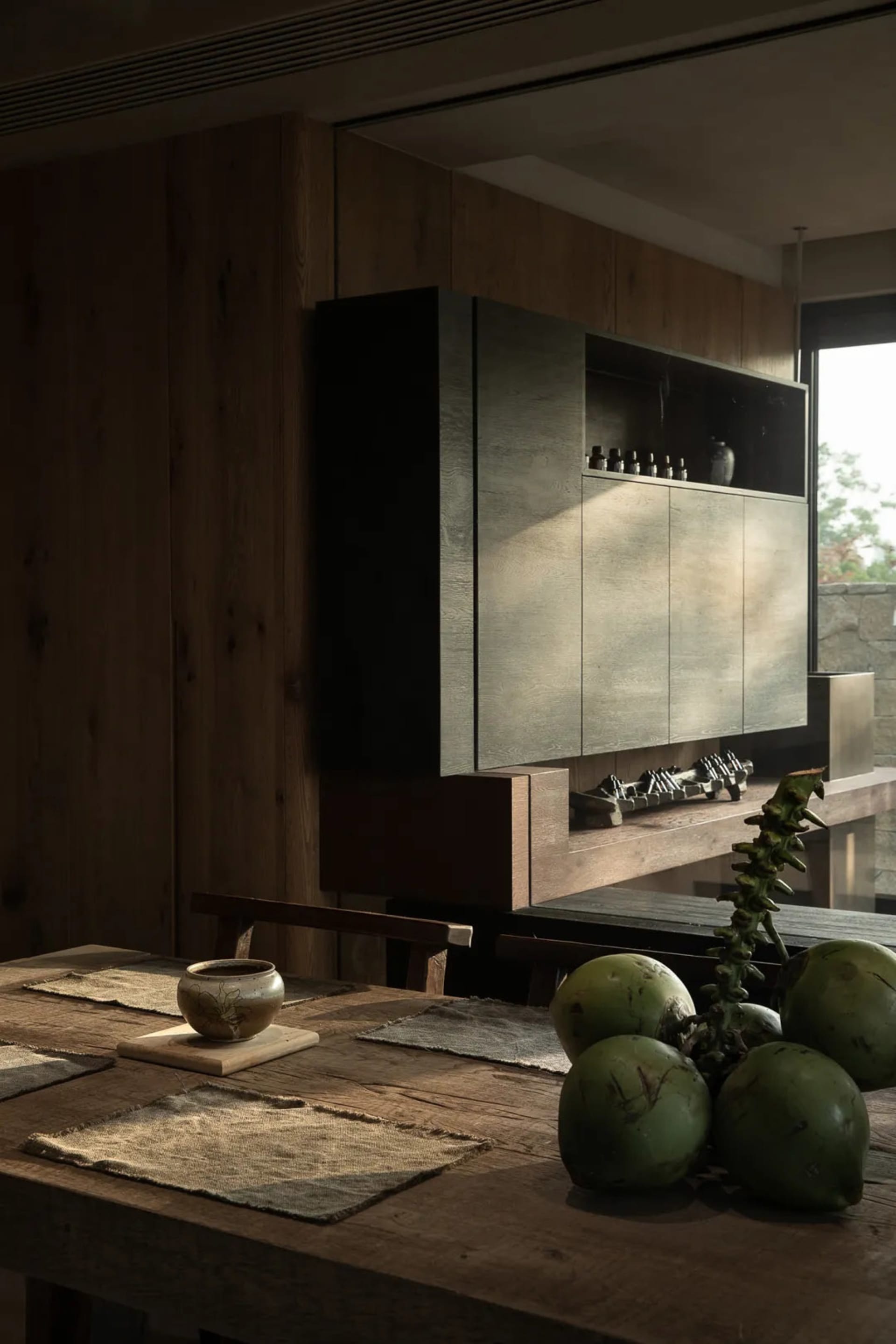 A modern kitchen with wooden cabinets and a wooden dining table.