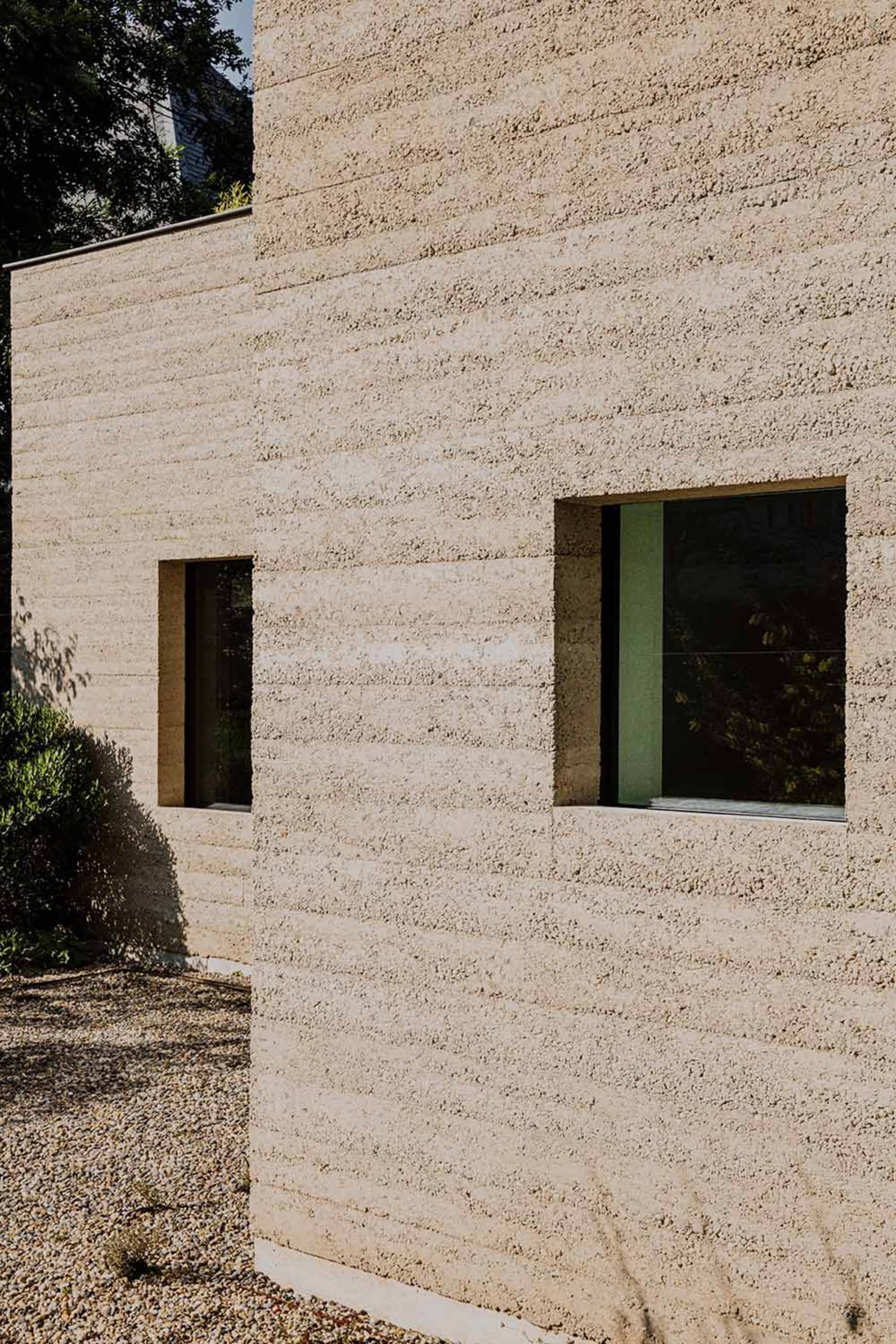 Modern building exterior with concrete walls and small windows