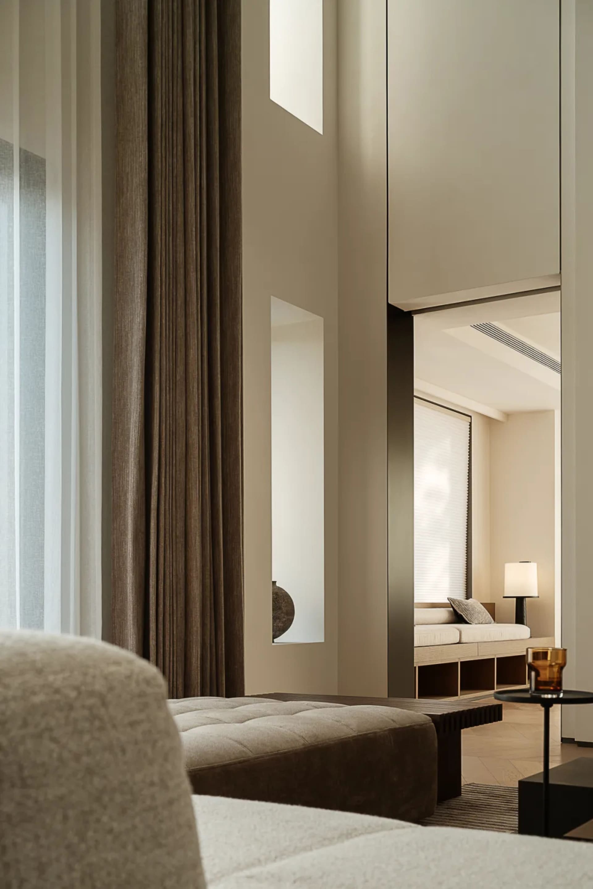 Modern minimalist living room with fabric seating and wooden accents.