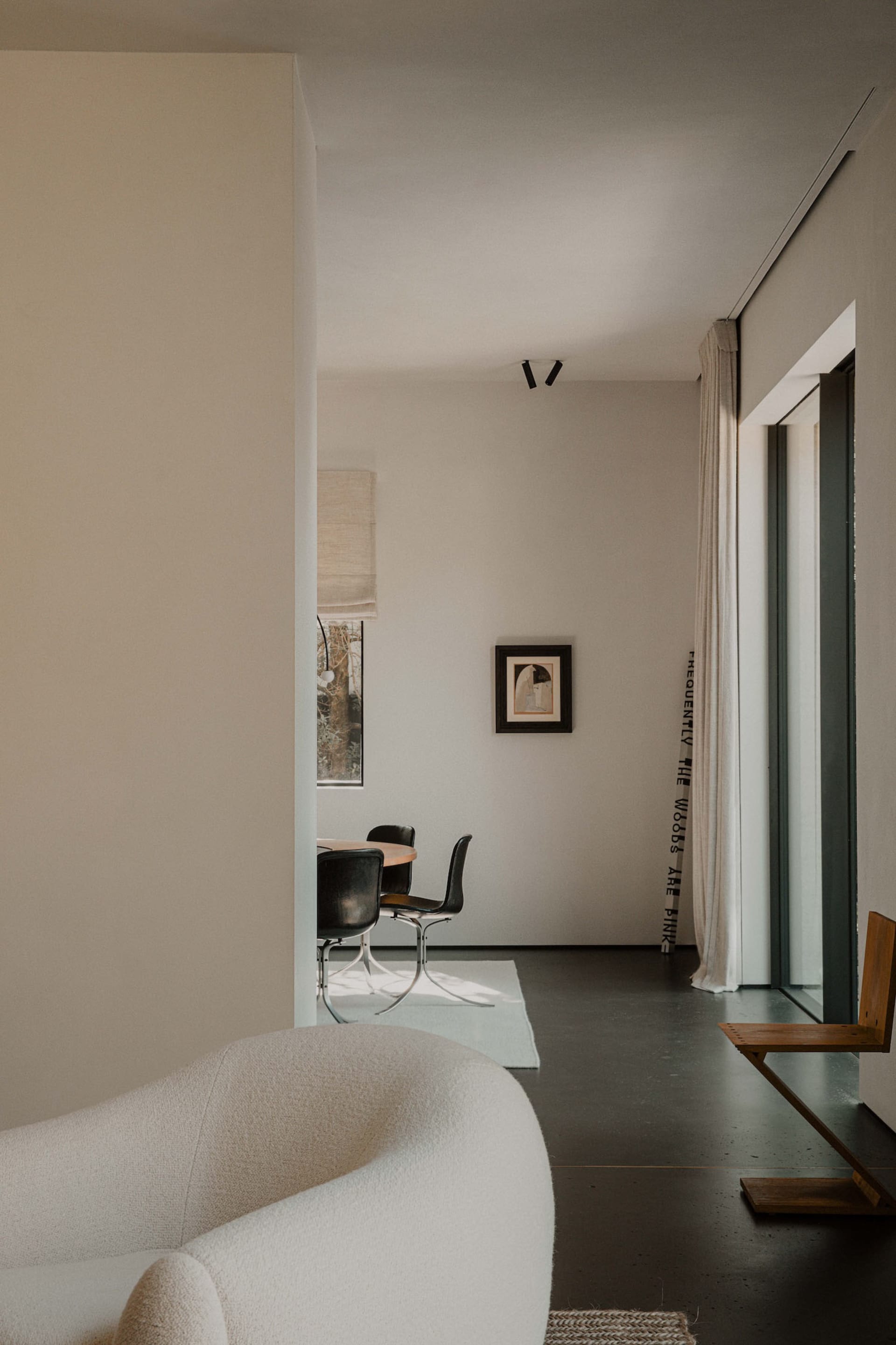 Contemporary interior design featuring neutral colors and minimalist furniture in a living room setting.
